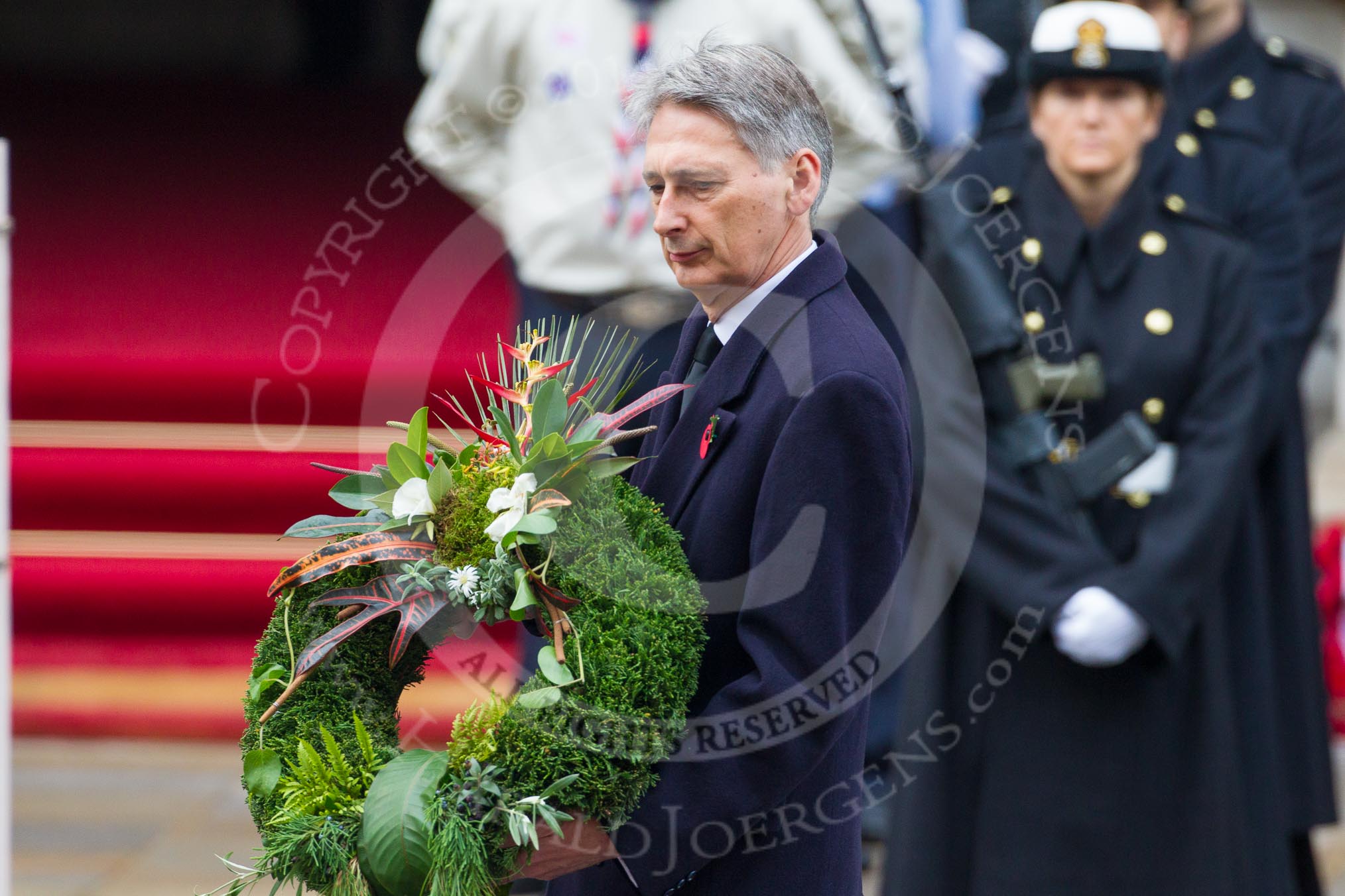 Remembrance Sunday at the Cenotaph in London 2014: Philip Hammond, Secretary of State for Foreign and Commonwealth Affairs, on the way to the Cenotaph to lay his wreath.
Press stand opposite the Foreign Office building, Whitehall, London SW1,
London,
Greater London,
United Kingdom,
on 09 November 2014 at 11:09, image #235