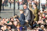 Remembrance Sunday at the Cenotaph in London 2014: Spectators on the eastern side of Whitehall waiting for the barriers to be removed..
Press stand opposite the Foreign Office building, Whitehall, London SW1,
London,
Greater London,
United Kingdom,
on 09 November 2014 at 12:24, image #319