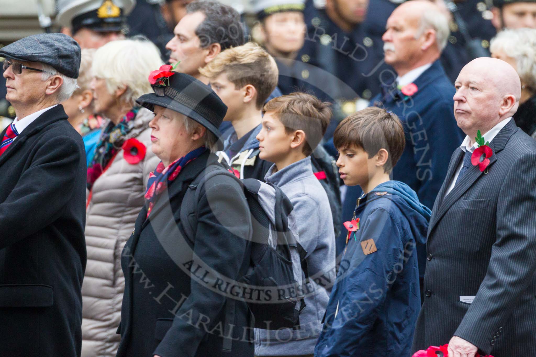 Remembrance Sunday at the Cenotaph 2015: Group M23, Civilians Representing Families.
Cenotaph, Whitehall, London SW1,
London,
Greater London,
United Kingdom,
on 08 November 2015 at 12:17, image #1561