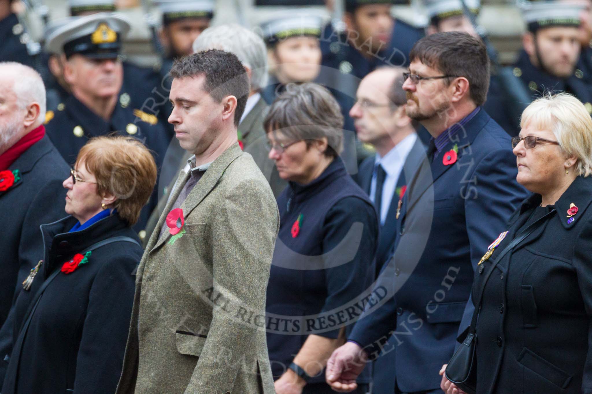 Remembrance Sunday at the Cenotaph 2015: Group M23, Civilians Representing Families.
Cenotaph, Whitehall, London SW1,
London,
Greater London,
United Kingdom,
on 08 November 2015 at 12:17, image #1564