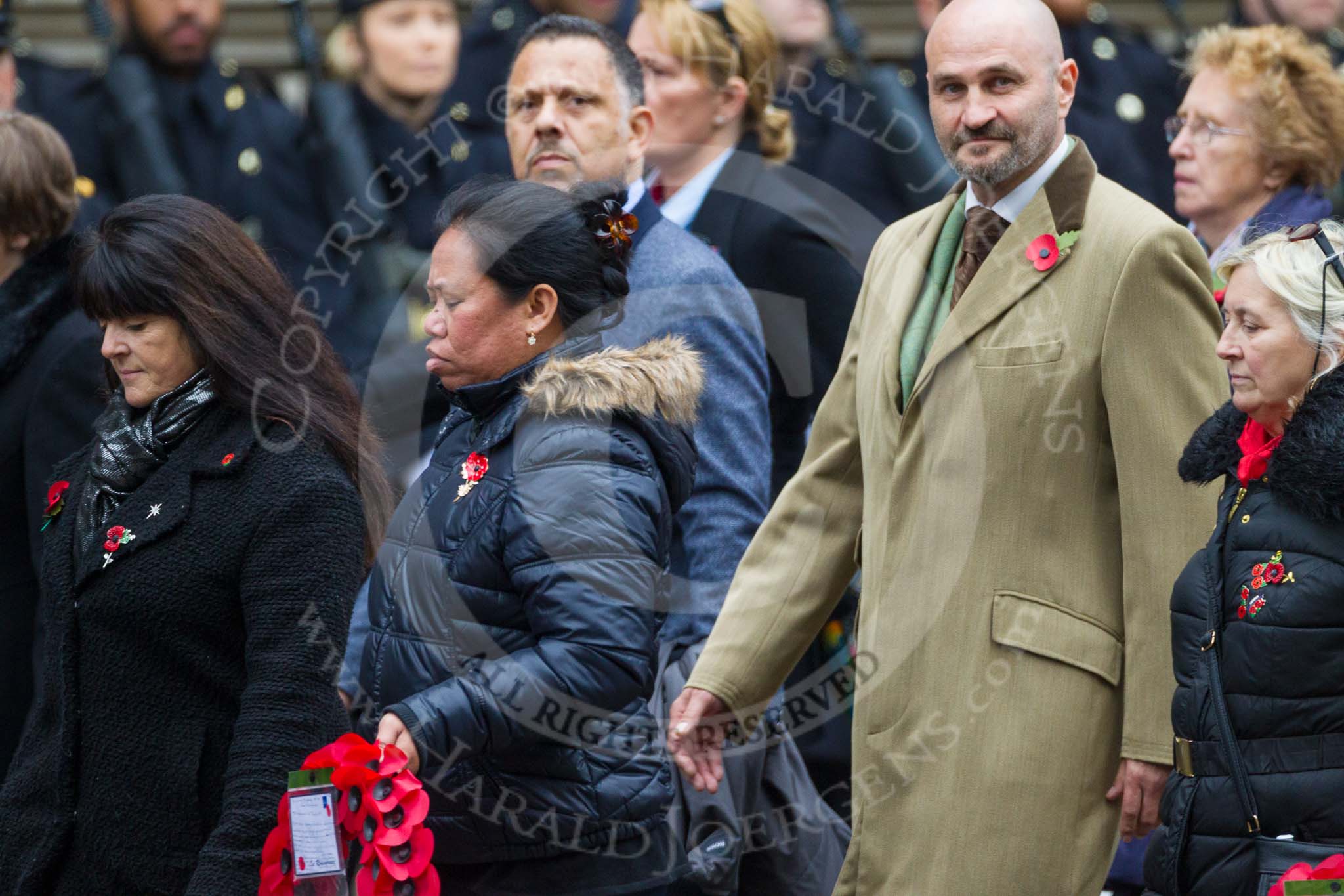 Remembrance Sunday at the Cenotaph 2015: Group M23, Civilians Representing Families.
Cenotaph, Whitehall, London SW1,
London,
Greater London,
United Kingdom,
on 08 November 2015 at 12:17, image #1570