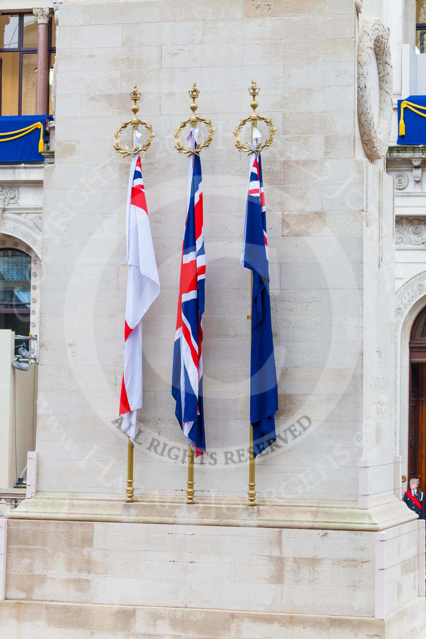 Remembrance Sunday at the Cenotaph 2015: The Cenotaph in the morning of Remembrance Sunday 2015. The tree flags represent the Royal Navy, the British Army, the Royal Air Force, and the Merchant Navy. Image #2, 08 November 2015 08:20 Whitehall, London, UK