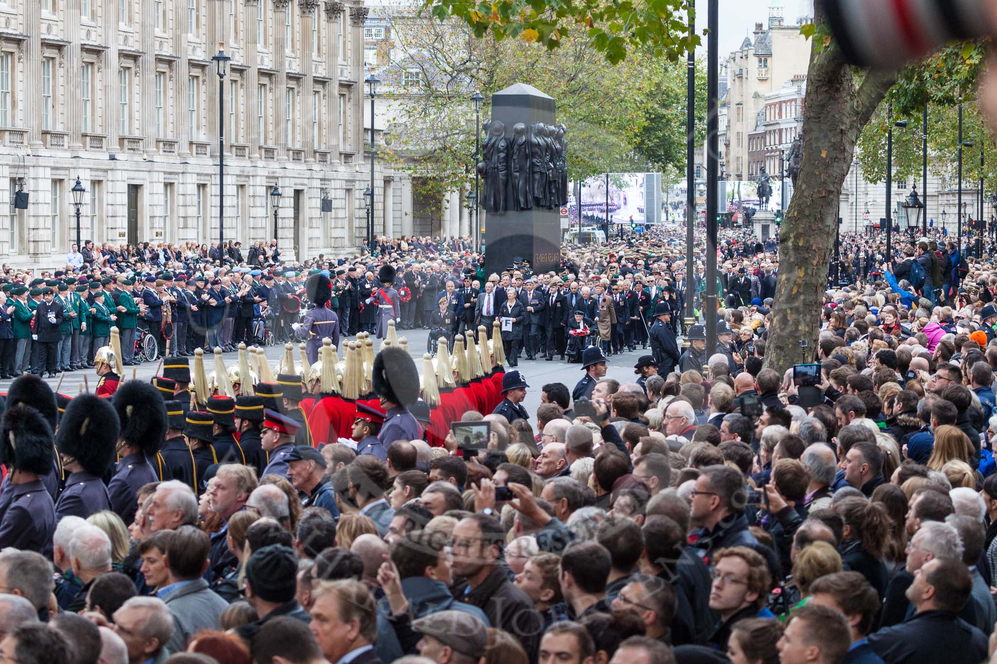 Remembrance Sunday at the Cenotaph 2015: The eastern side of Whitehall, with the three columns of veterans, waiting for the March Past, between the large numbers of specators lining both sides of the road. Image #69, 08 November 2015 10:45 Whitehall, London, UK