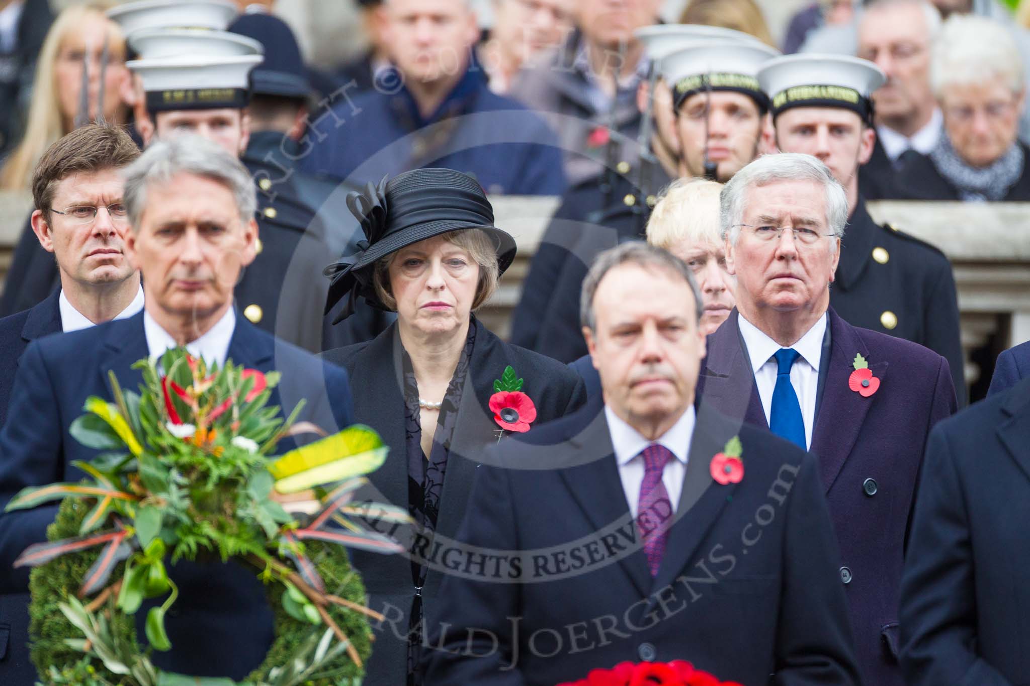 Remembrance Sunday at the Cenotaph 2015: In focus in the second row The Rt Hon Greg Clark MP (Secretary of State for Communities and Local Government), The Rt Hon Theresa May MP (Secretary of State for the Home Department), and The Rt Hon Michael Fallon MP (Secretary of State for Defence). Image #153, 08 November 2015 11:02 Whitehall, London, UK