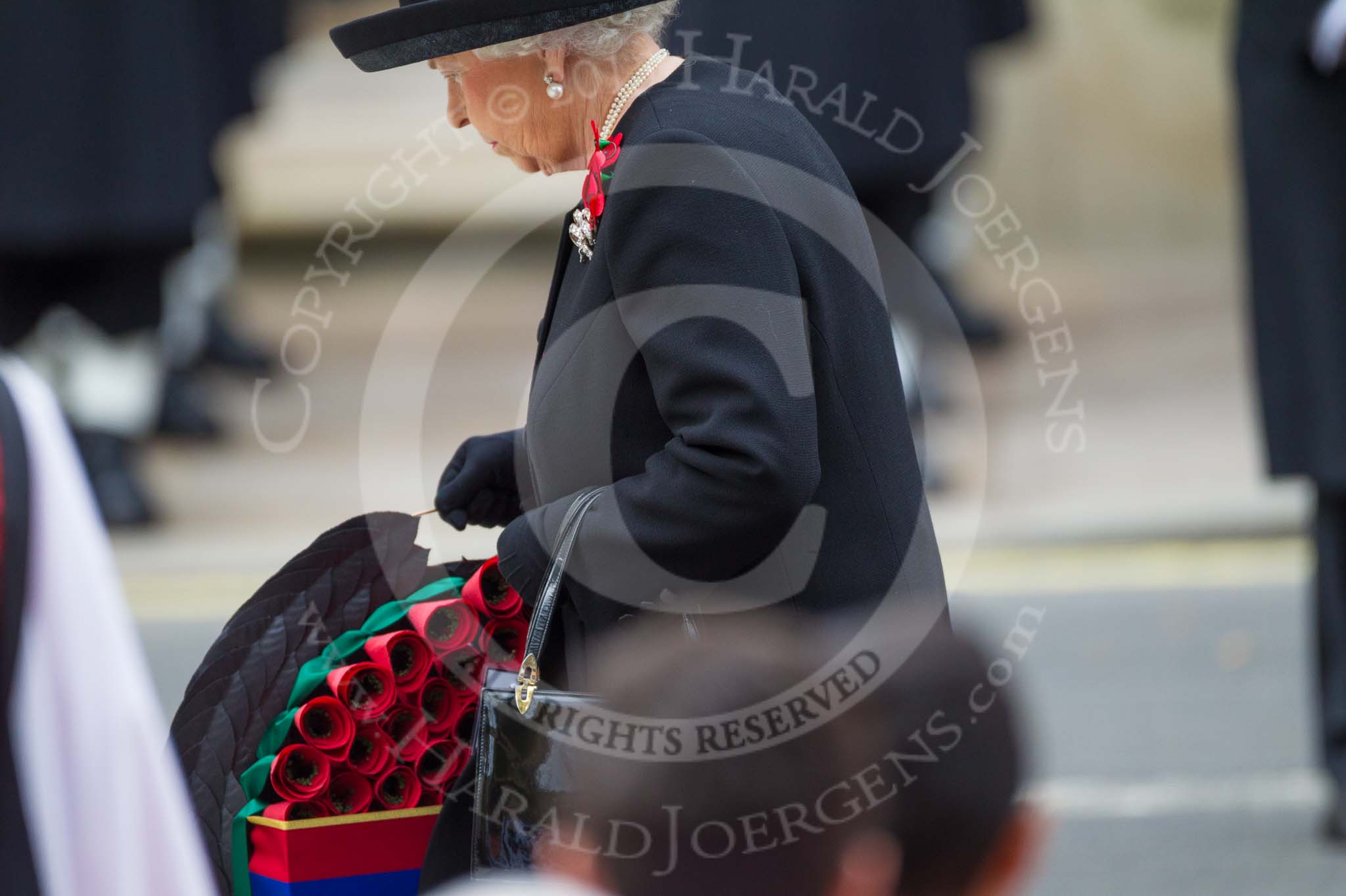 Remembrance Sunday at the Cenotaph 2015: HM The Queen walking toward the Cenotaph with her wreath. Image #174, 08 November 2015 11:03 Whitehall, London, UK