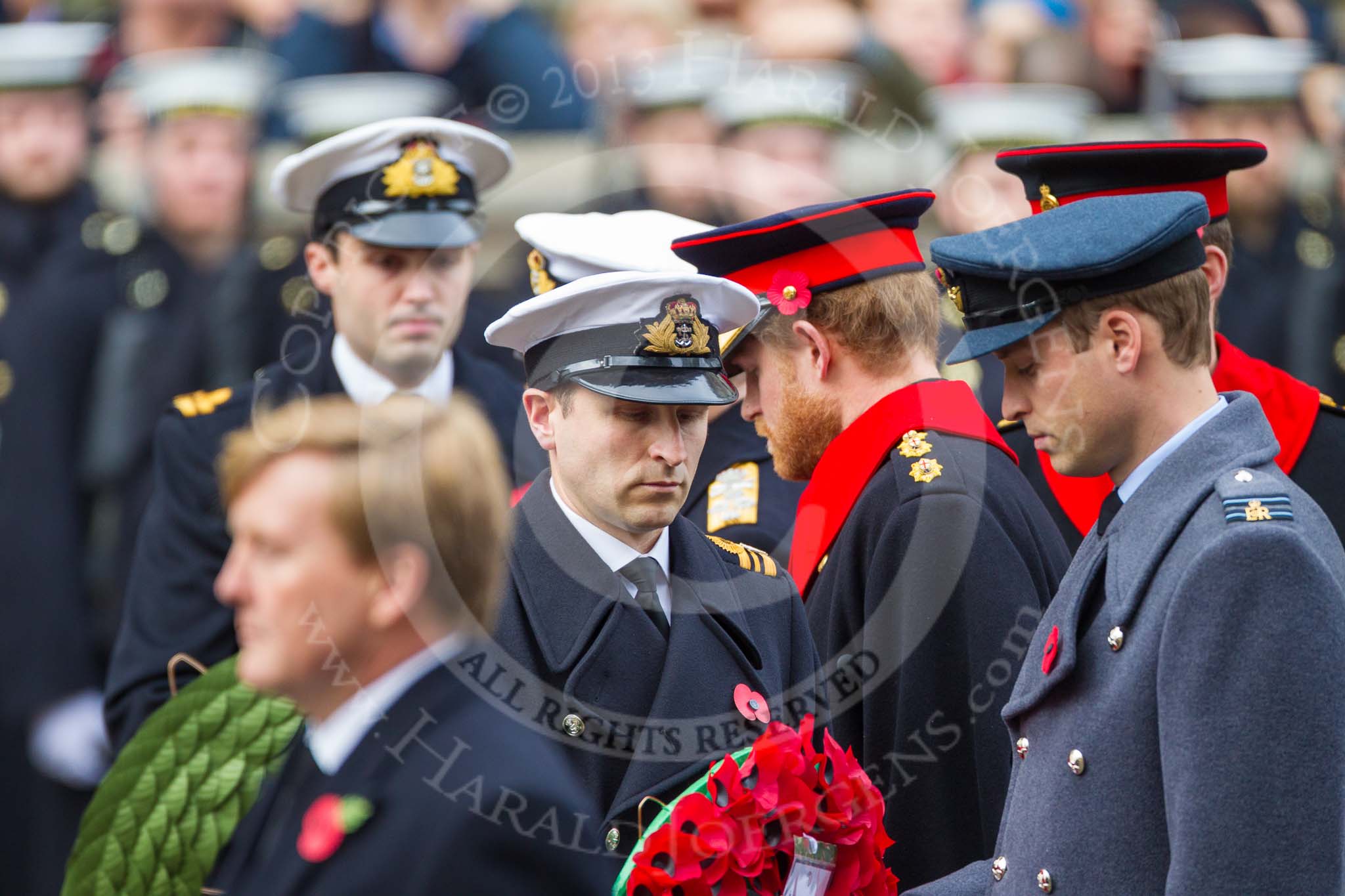 Remembrance Sunday at the Cenotaph 2015: The Equerry to HRH The Duke of Cambridge,  Lieutenant  Commander  James  Benbow, Royal Navy, handing over the wreath to Prince William. Behind them, Captain  Edward  Lane  Fox, Equerry to HRH Prince Henry of Wales, is handing over the wreath to Prince Harry. Image #189, 08 November 2015 11:05 Whitehall, London, UK