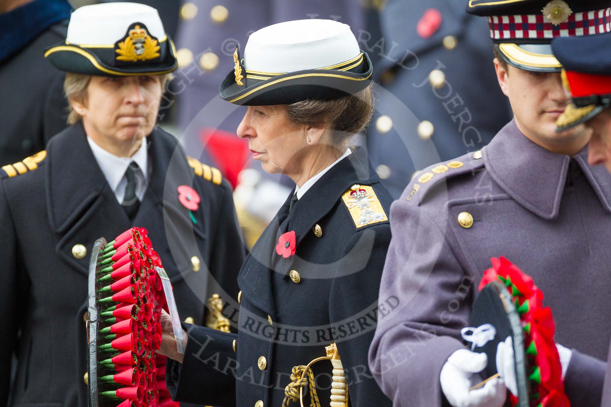 Remembrance Sunday at the Cenotaph 2015: HRH The Princess Royal receiving the wreath from her equerry, Commander  Anne  Sullivan,  Royal Navy. In the foreground, HRH The Duke of Kent takes the wreath from his equerry, Captain  Edward  Dalrymple  Hamilton. Image #196, 08 November 2015 11:05 Whitehall, London, UK