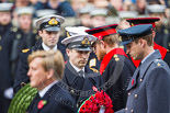 Remembrance Sunday at the Cenotaph 2015: The Equerry to HRH The Duke of Cambridge,  Lieutenant  Commander  James  Benbow, Royal Navy, handing over the wreath to Prince William. Behind them, Captain  Edward  Lane  Fox, Equerry to HRH Prince Henry of Wales, is handing over the wreath to Prince Harry. Image #189, 08 November 2015 11:05 Whitehall, London, UK