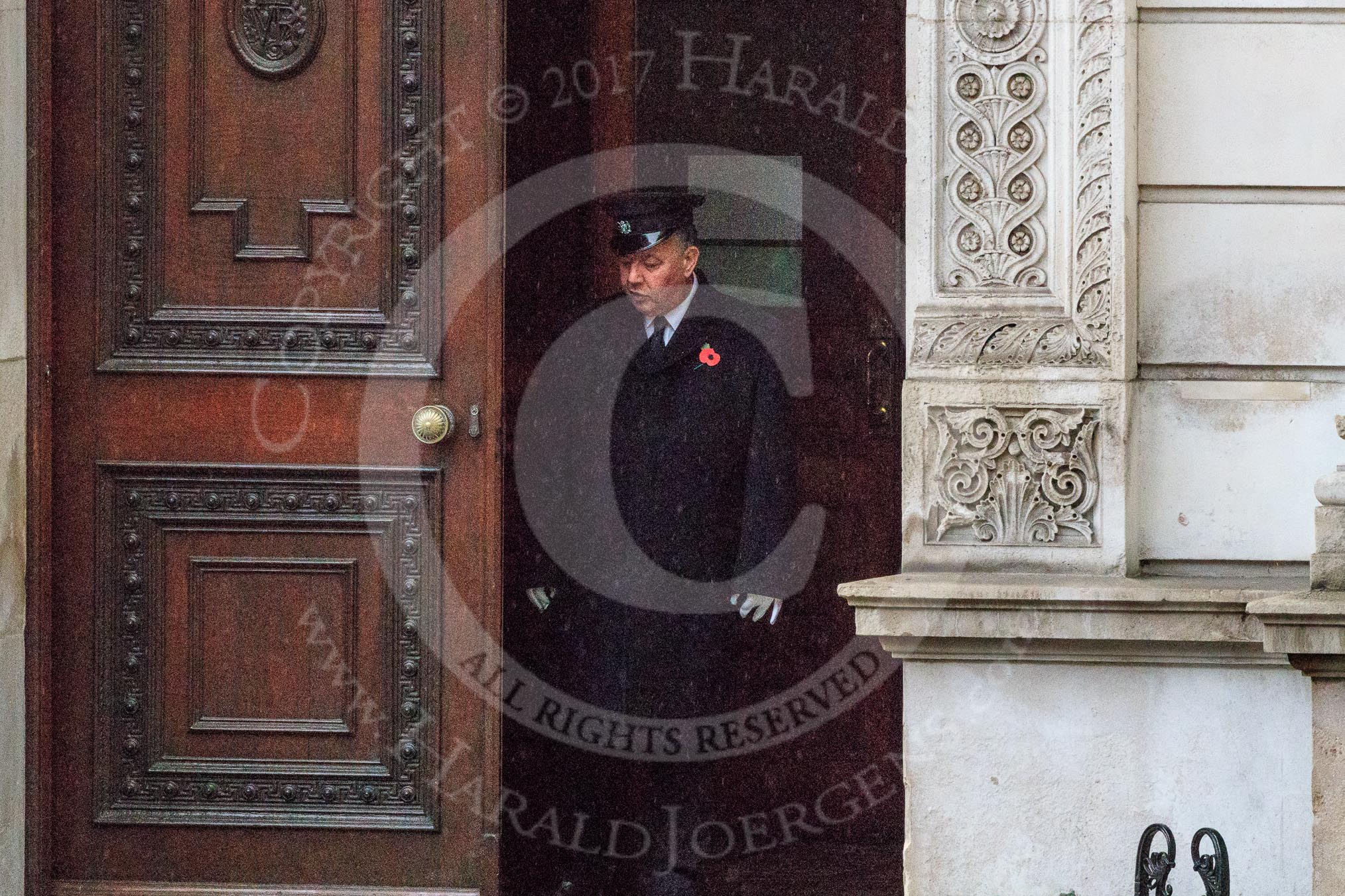 The doors of the Foreign and Commonwealth Office are opened on a wet morning before the Remembrance Sunday Cenotaph Ceremony 2018 at Horse Guards Parade, Westminster, London, 11 November 2018, 08:04.