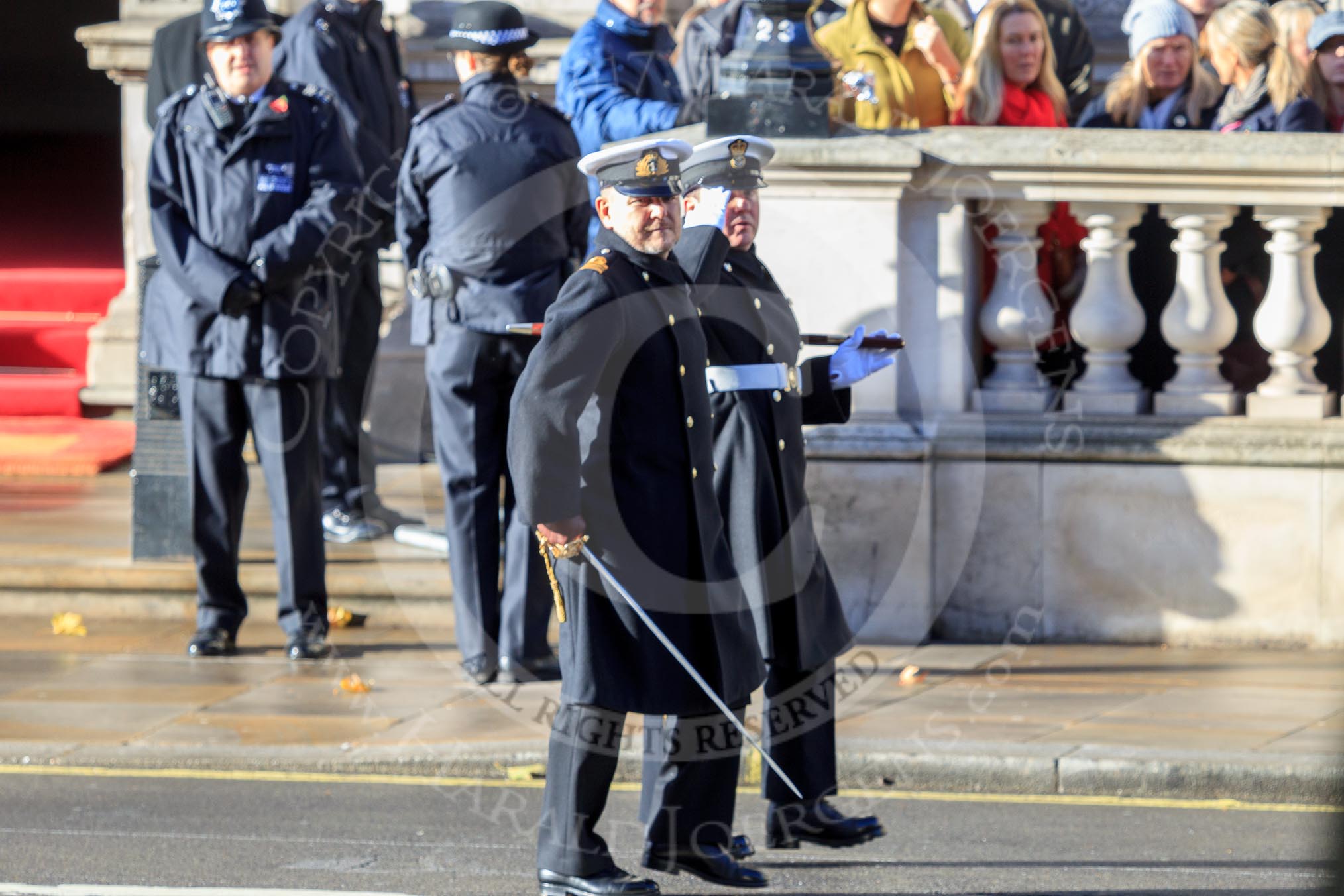 Two Royal Navy officers arriving on Whitehall ahead of their service detachment, before the Remembrance Sunday Cenotaph Ceremony 2018 at Horse Guards Parade, Westminster, London, 11 November 2018, 10:07.