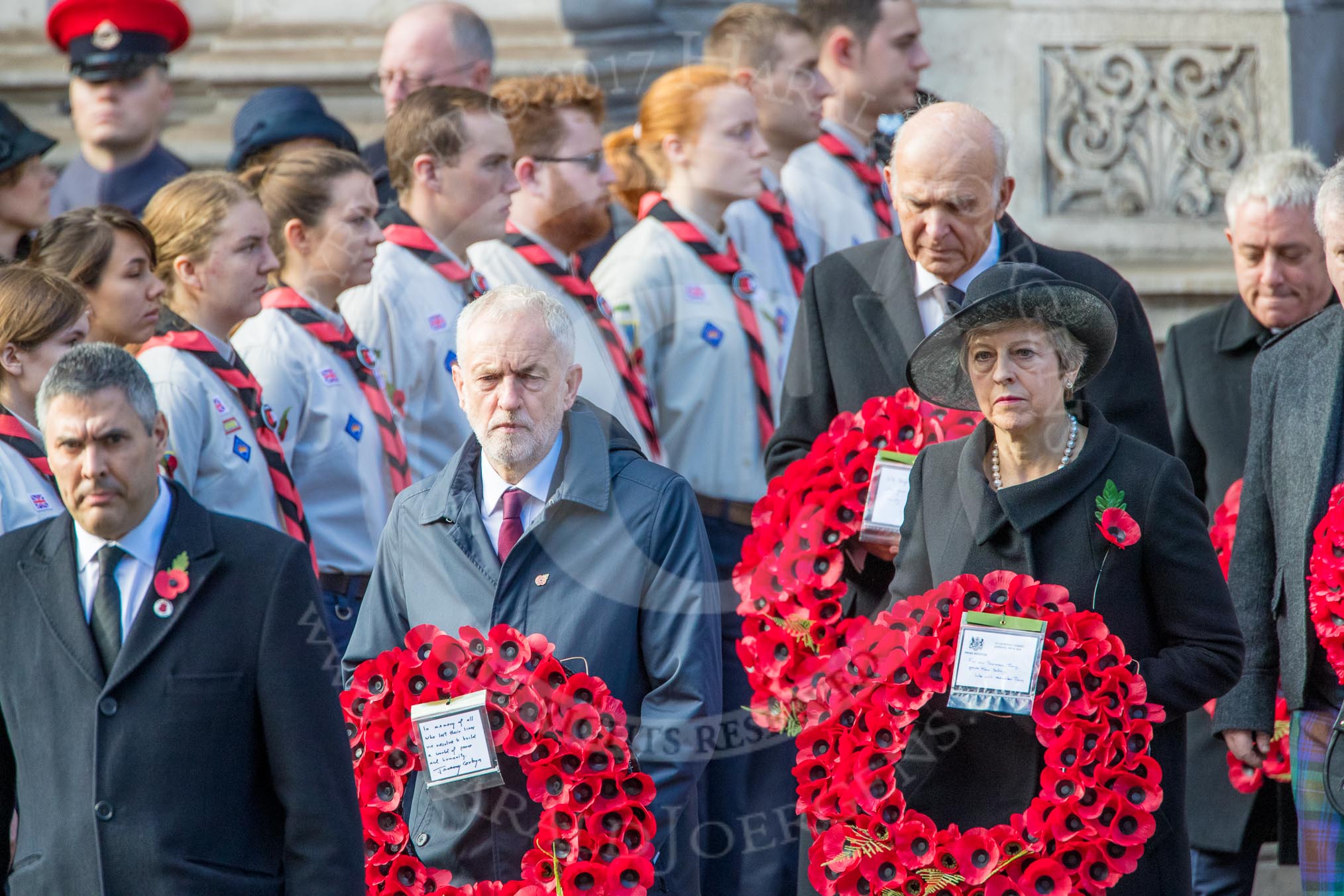 The Rt Hon Jeremy Corbyn MP, (Leader of the Labour Party and Leader of the Opposition)   and the Rt Hon Theresa May MP, Prime Minister, on behalf of the Government, leaving the Foreign and Commonwealth Office with their wreath during Remembrance Sunday Cenotaph Ceremony 2018 at Horse Guards Parade, Westminster, London, 11 November 2018, 10:55.