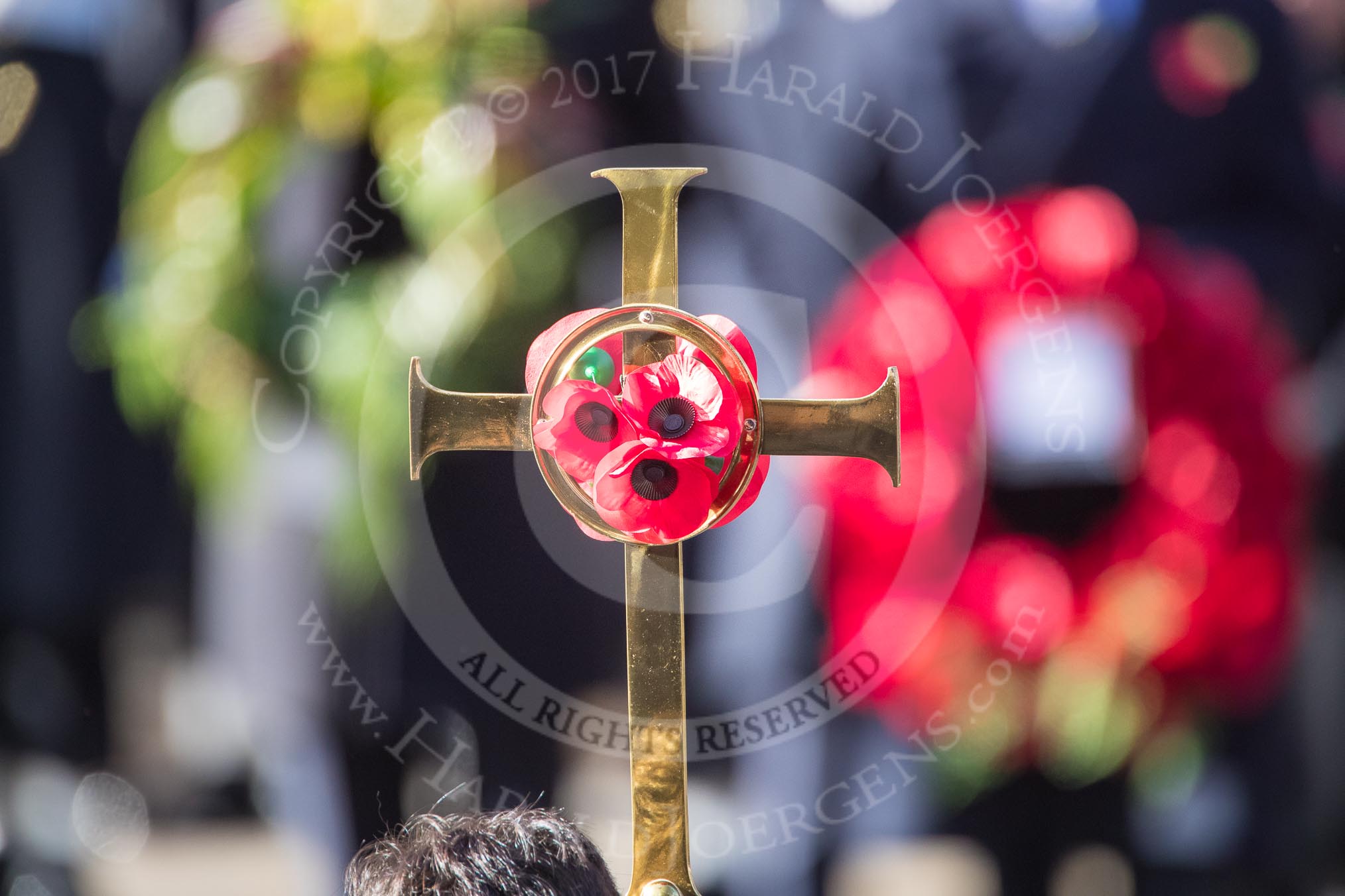 The cross with the poppies, held by the Cross­Bearer, Michael Clayton Jolly, during Remembrance Sunday Cenotaph Ceremony 2018 at Horse Guards Parade, Westminster, London, 11 November 2018, 10:58.
