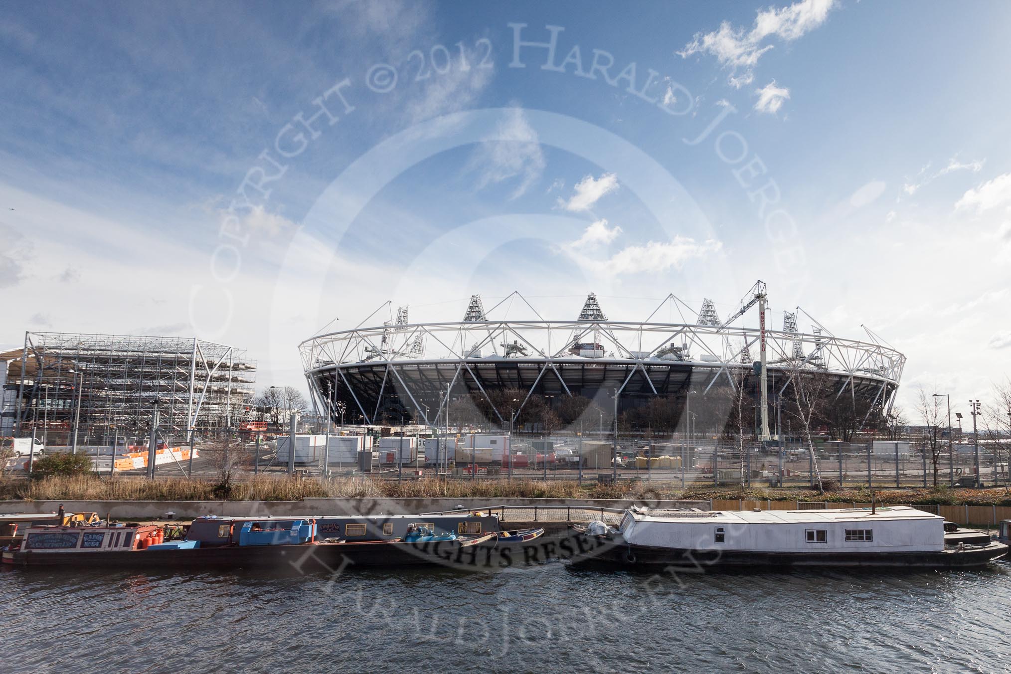 The Boat Race season 2012 - Crew Announcement and Weigh In: The River Stoar seen from Forman's Fish Island. Behind the moored narrowboats the Olympic Park, with the Olympic Stadium on the right..
Forman's Fish Island,
London E3,

United Kingdom,
on 05 March 2012 at 10:44, image #60