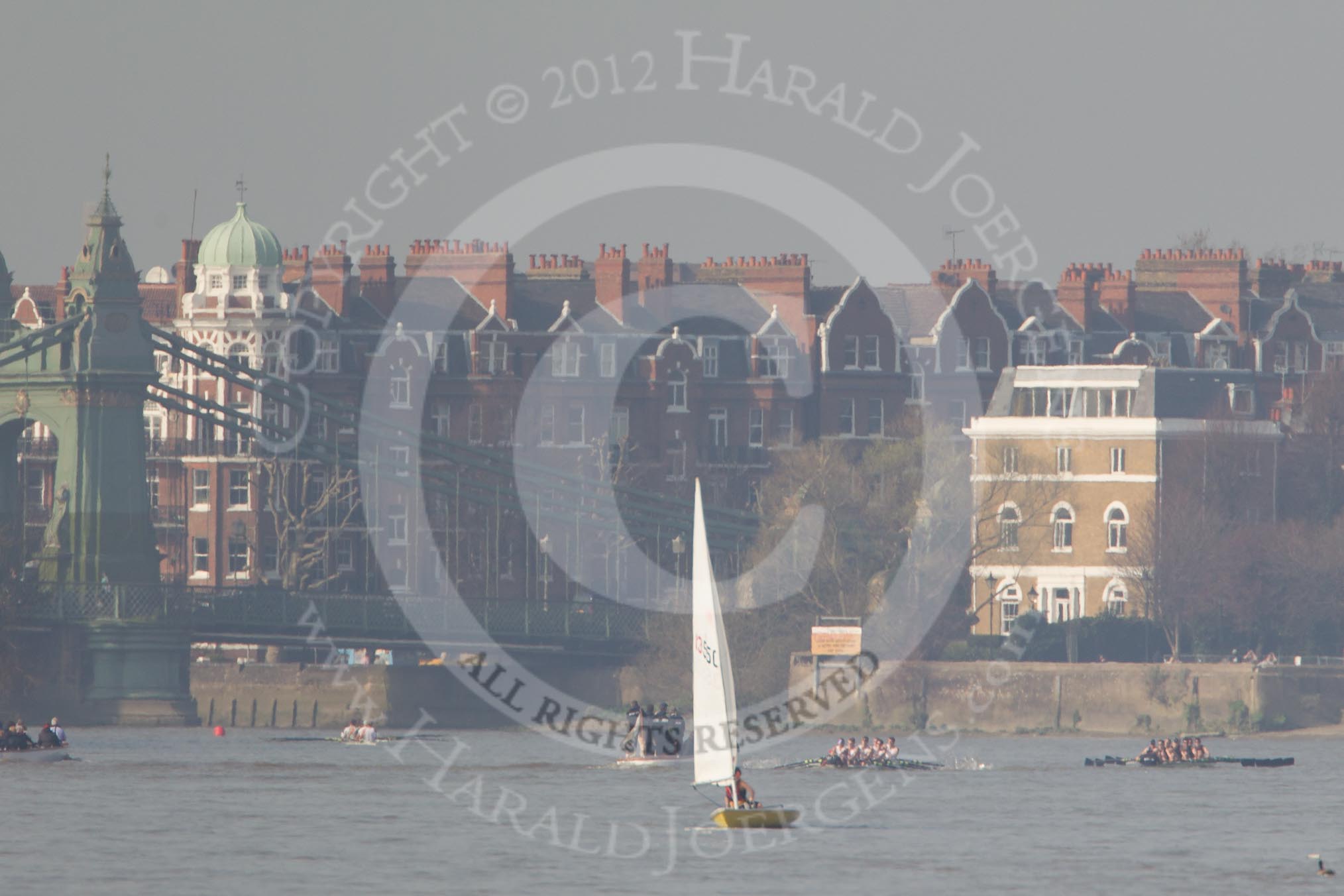 The Boat Race season 2012 - fixture OUBC vs Leander: Approaching Hammersmith Bridge, the OUBC Blue Boat in the lead, Leander, followed by umpire Richard Phelps, behind. Just visible under Hammersmith Bridge the CUBC Blue Boat..




on 24 March 2012 at 14:33, image #143