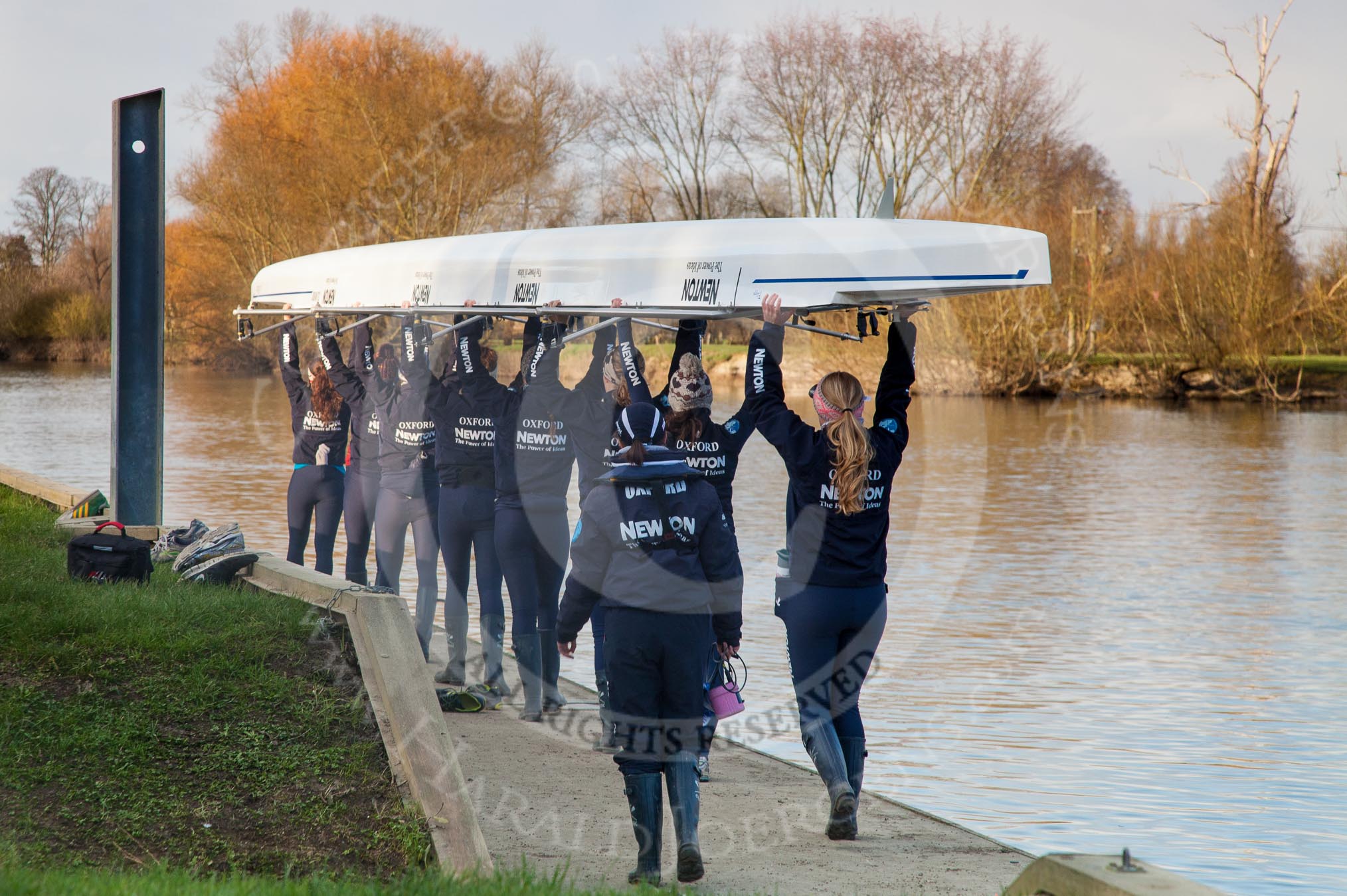 The Boat Race season 2013 - OUWBC training: The crew of the OUWBC reserve boat Osiris getting ready for training at Fleming Boathouse: bow Coralie Viollet-Djelassi, Elspeth Cumber, Hannah Ledbury, Eleanor Darlington, Rachel Purkess, Caitlin Goss, Annika Bruger, stroke Emily Chittock, and cox Sophie Shawdon..
Fleming Boathouse,
Wallingford,
Oxfordshire,
United Kingdom,
on 13 March 2013 at 16:50, image #23