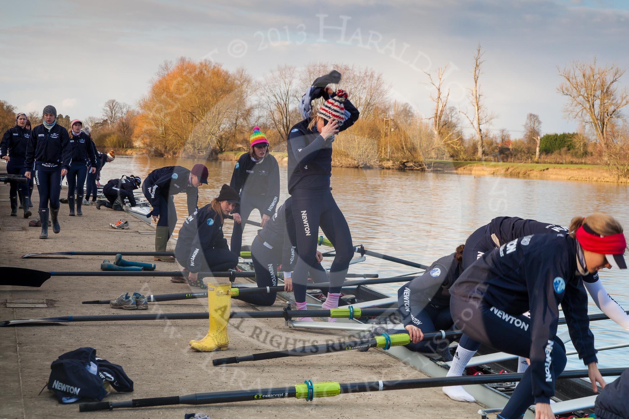 The Boat Race season 2013 - OUWBC training: The OUWBC Blue Boat squad getting ready at Fleming Boathouse - bow Mariann Novak, Alice Carrington-Windo, Mary Foord-Weston, Jo Lee, Amy Varney, Harriet Keane, Anastasia Chitty, stroke Maxie Scheske, and cox Katie Apfelbaum. In the background the Osiris crew..
Fleming Boathouse,
Wallingford,
Oxfordshire,
United Kingdom,
on 13 March 2013 at 16:50, image #24