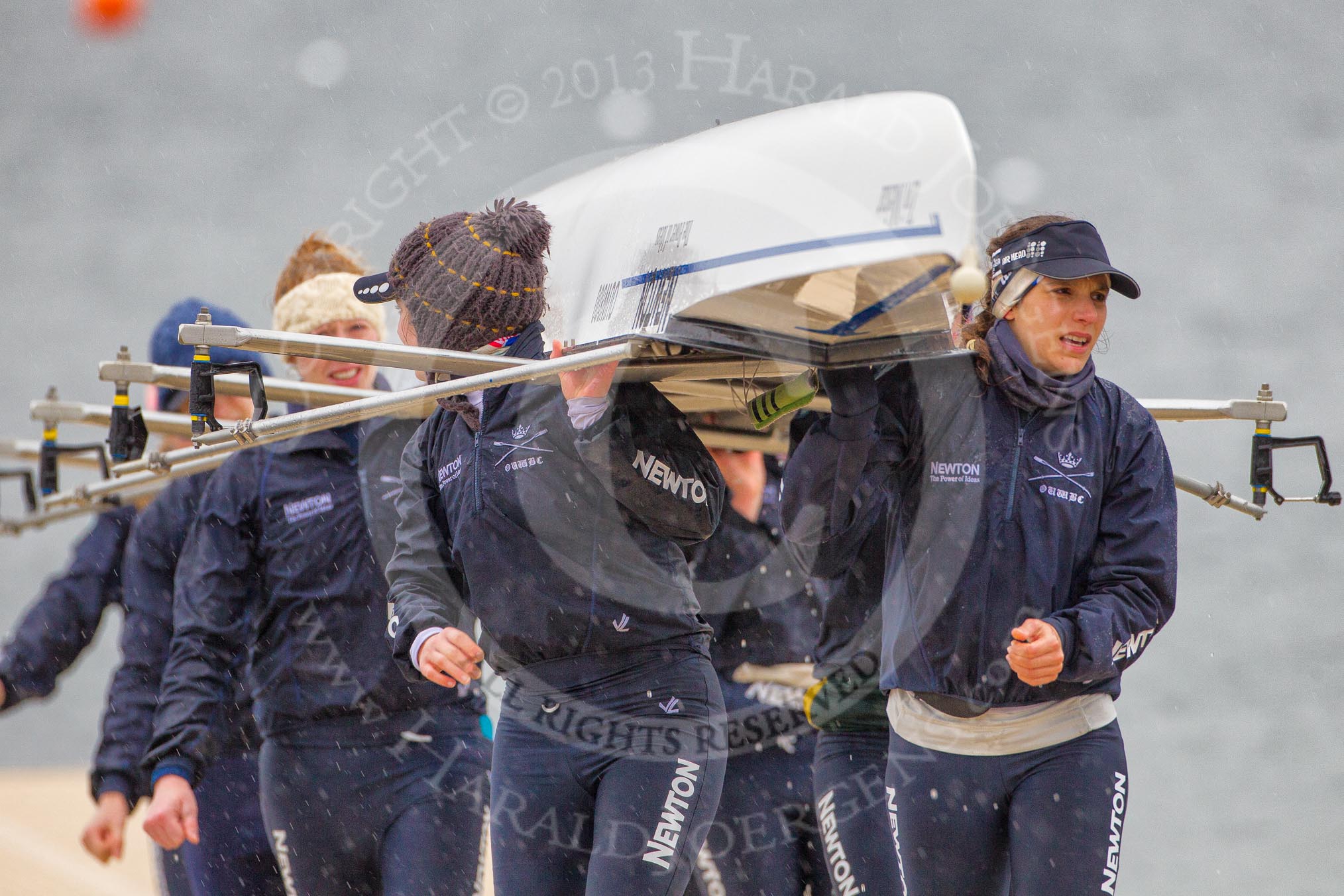 The Boat Race season 2013 - fixture OUWBC vs Olympians: The crew of the OUWBC reserve boat Osiris, carrying their boat afther a training session in pouring rain and freezing cold at Dorney Lake. In front right bow lady Coralie Viollet-Djelassi..
Dorney Lake,
Dorney, Windsor,
Buckinghamshire,
United Kingdom,
on 16 March 2013 at 09:59, image #4