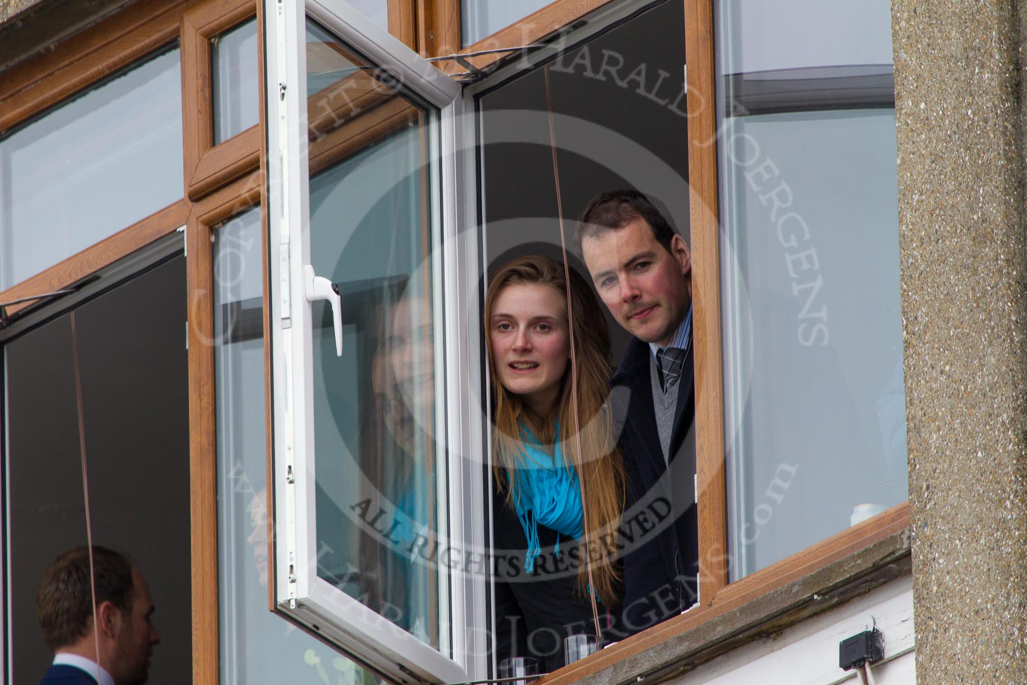The Boat Race 2013: Two Boat Race spectators watching from one of the windows of a Putney Embankment boathouse..
Putney,
London SW15,

United Kingdom,
on 31 March 2013 at 14:38, image #88