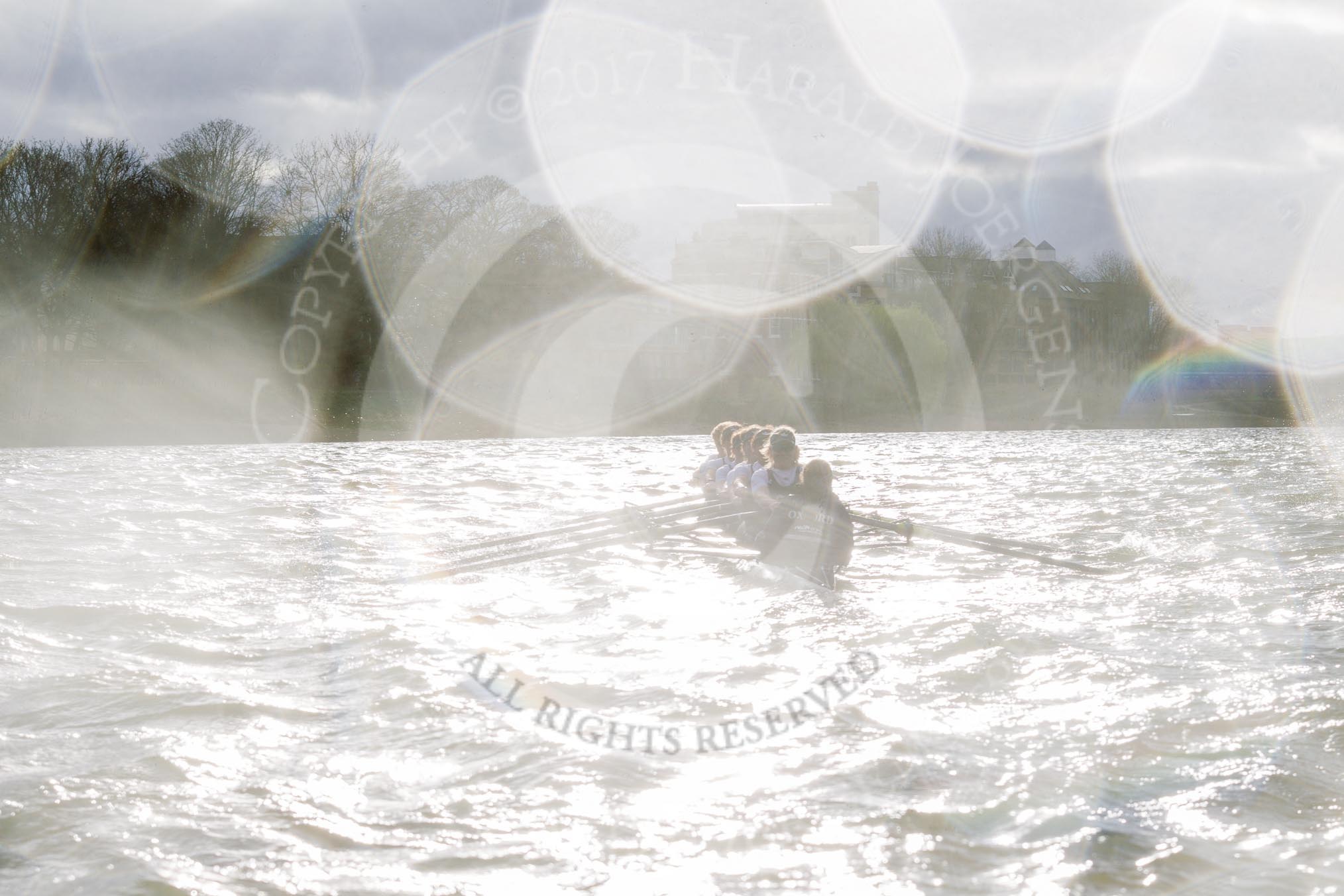 The Cancer Research UK Boat Race season 2017 - Women's Boat Race Fixture OUWBC vs Molesey BC: OUWBC hardly visible against the low sun, and spray on the lens.
River Thames between Putney Bridge and Mortlake,
London SW15,

United Kingdom,
on 19 March 2017 at 16:23, image #146