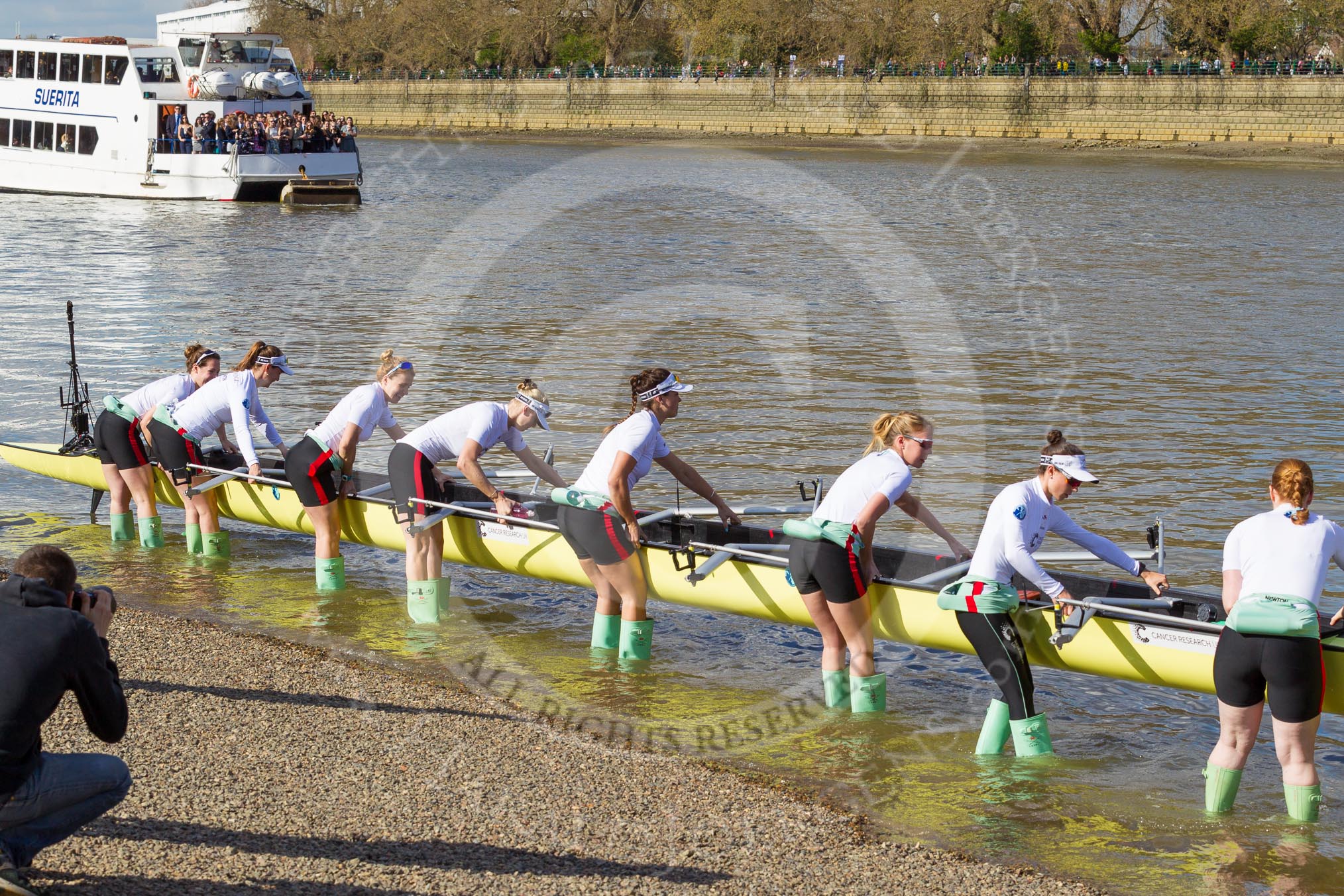 The Boat Race season 2017 -  The Cancer Research Women's Boat Race: The CUWBC crew getting their boat onto the river, here stroke Melissa Wilson, 7 Myriam Goudet, 6 Alice White, 5 Holly Hill, 4 Anna Dawson, 3 Claire Lambe, 2 Imogen Grant, bow Ashton Brown.
River Thames between Putney Bridge and Mortlake,
London SW15,

United Kingdom,
on 02 April 2017 at 15:47, image #61