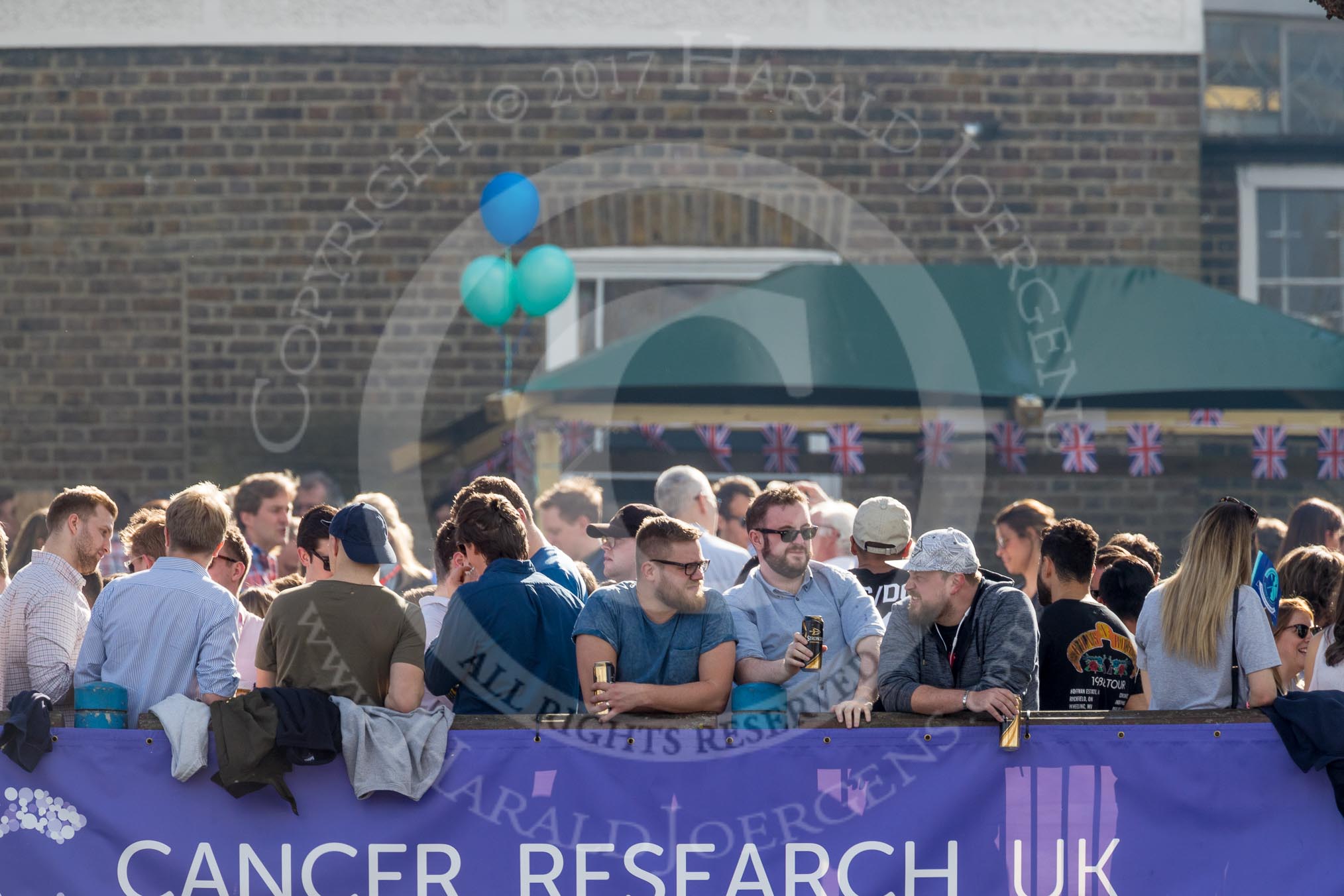 The Boat Race season 2017 -  The Cancer Research Women's Boat Race: Waiting for The Boat Race on a sunny day - spectators at one of the riverside pubs in Putney.
River Thames between Putney Bridge and Mortlake,
London SW15,

United Kingdom,
on 02 April 2017 at 16:06, image #98