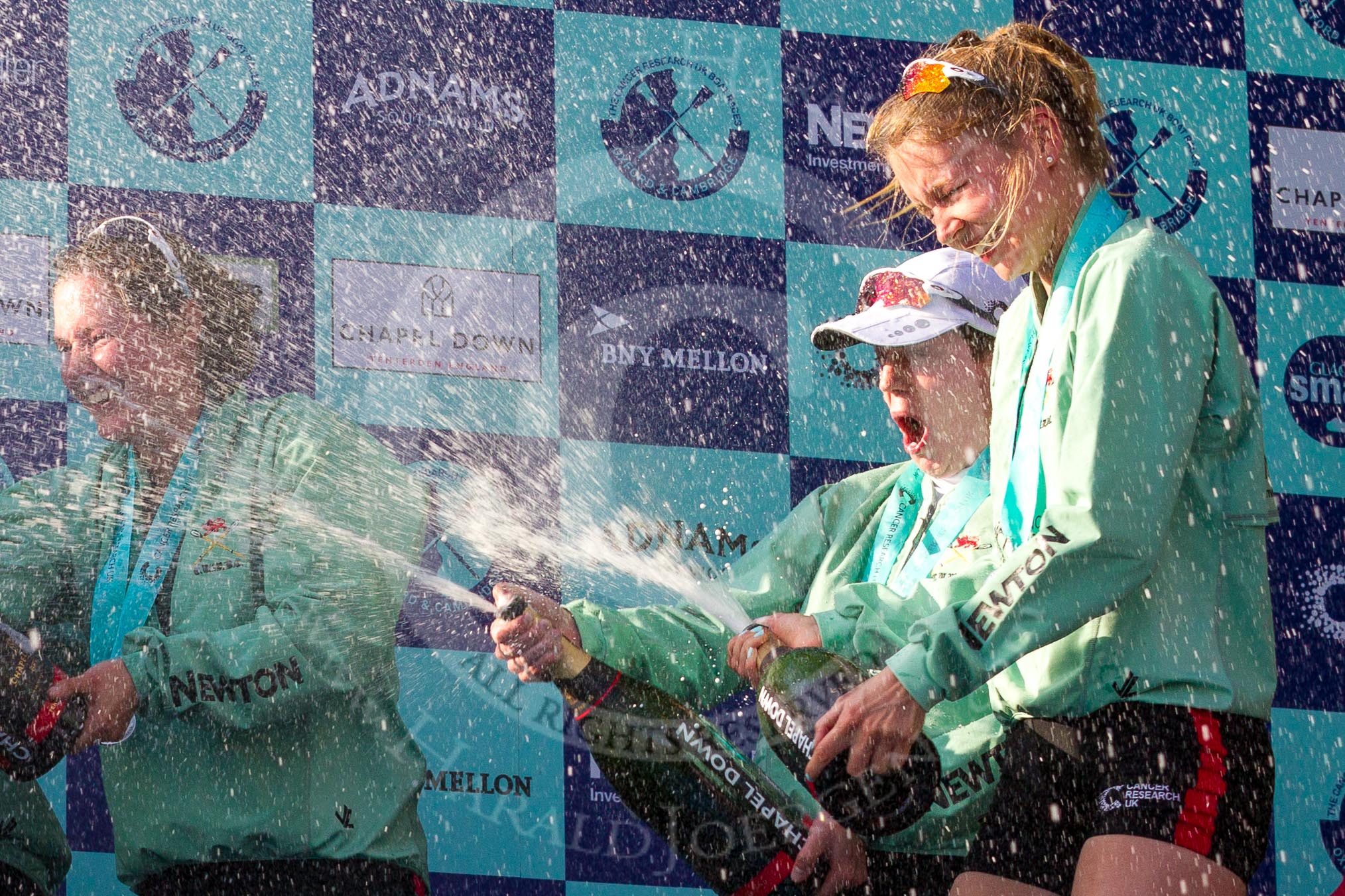 The Boat Race season 2017 -  The Cancer Research Women's Boat Race: CUWBC spraying the Champagne at the price giving - stroke Melissa Wilson, and cox Matthew Holland, and 4 seat Anna Dawson.
River Thames between Putney Bridge and Mortlake,
London SW15,

United Kingdom,
on 02 April 2017 at 17:13, image #268