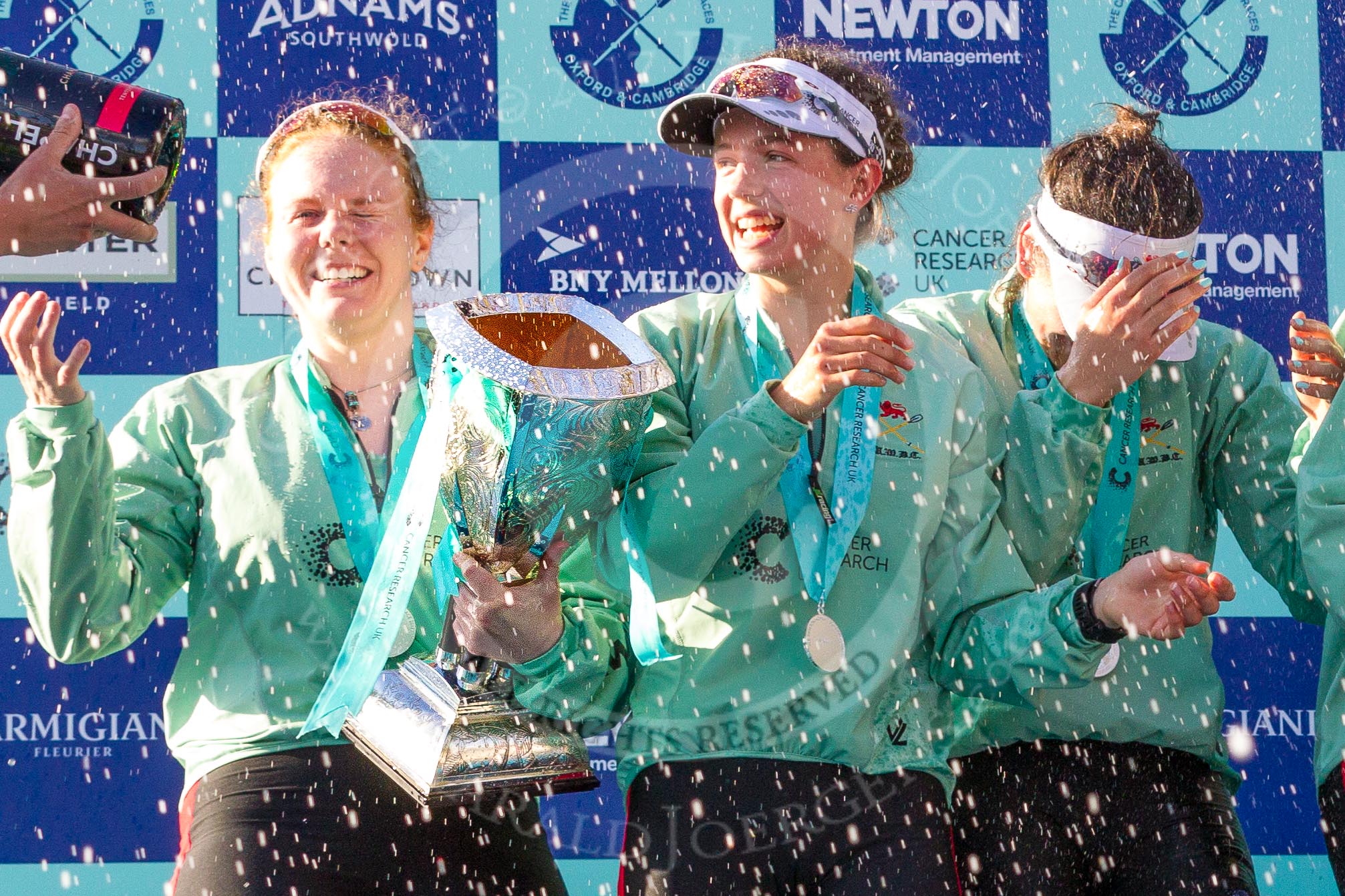 The Boat Race season 2017 -  The Cancer Research Women's Boat Race: CUWBC and lots of Champagne, here, with the Women's Boat Race trophy, bow Ashton Brown, 2 Imogen Grant, and 3 Claire Lambe.
River Thames between Putney Bridge and Mortlake,
London SW15,

United Kingdom,
on 02 April 2017 at 17:13, image #275