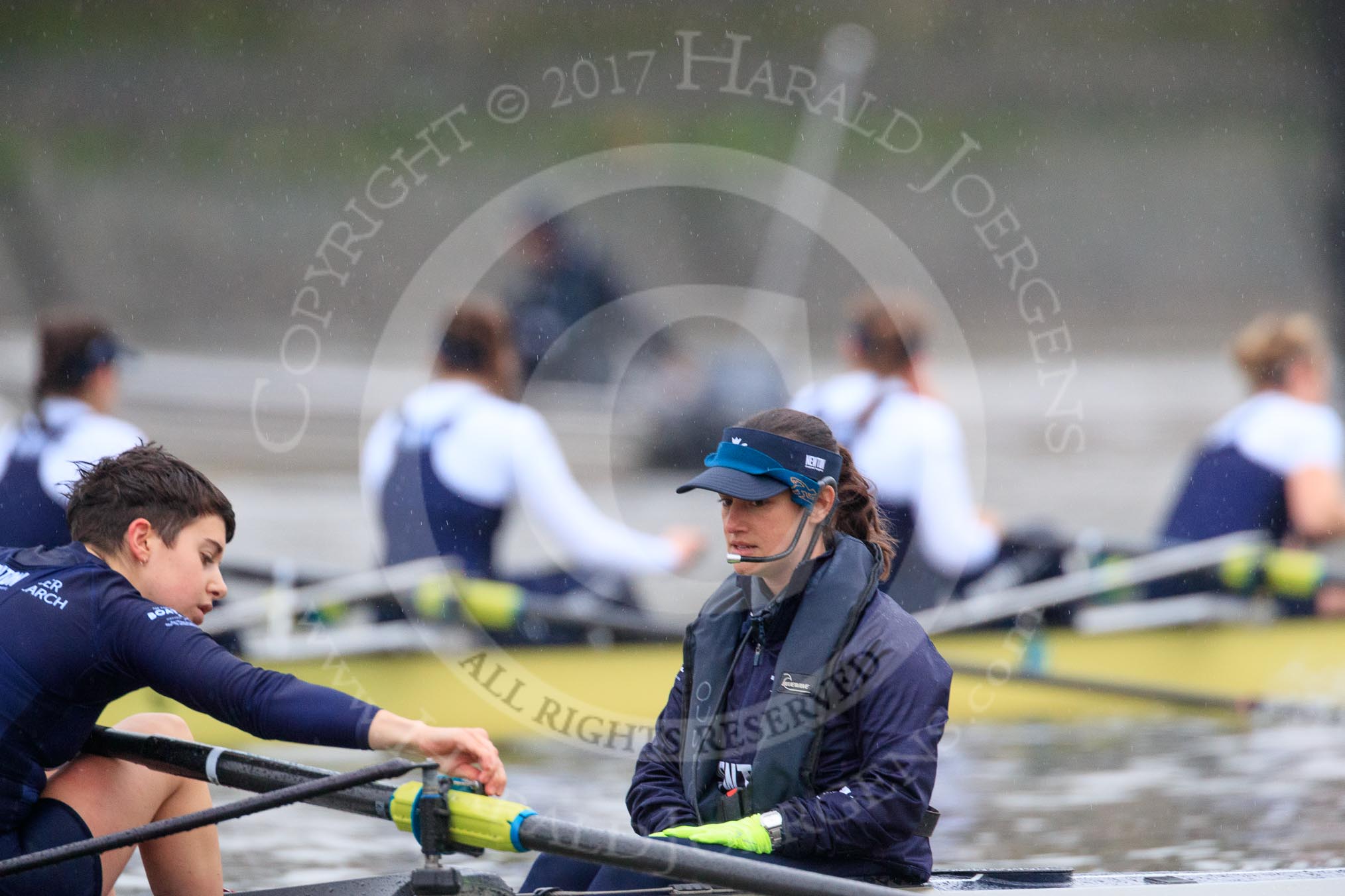 The Boat Race season 2018 - Women's Boat Race Trial Eights (OUWBC, Oxford): Adjustments before the race - stroke Alice Roberts, cox Jessica Buck on "Great Typhoon", with "Coursing River" (and the rain) in the background.
River Thames between Putney Bridge and Mortlake,
London SW15,

United Kingdom,
on 21 January 2018 at 14:23, image #36