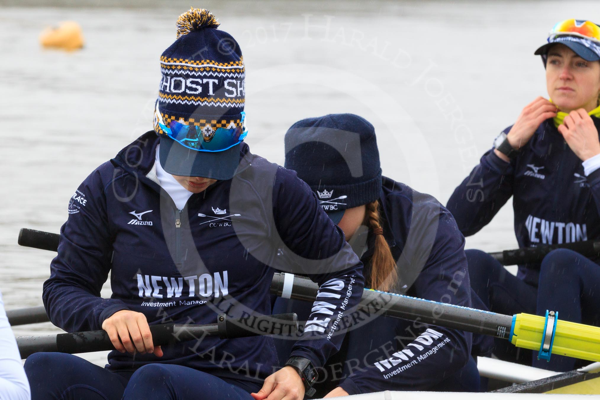 The Women's Boat Race season 2018 - fixture OUWBC vs. Molesey BC: OUWBC getting the boat ready on a cold and rainy day, here 4 seat "Ghost Ship" Alice Roberts, 3 Juliette Perry, 2 Katherine Erickson.
River Thames between Putney Bridge and Mortlake,
London SW15,

United Kingdom,
on 04 March 2018 at 13:05, image #5