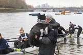 The Women's Boat Race season 2018 - fixture OUWBC vs. Molesey BC: Molesey cox Ella Taylor being carried to the boat by the MBC coach, much to the amusement of the crew.
River Thames between Putney Bridge and Mortlake,
London SW15,

United Kingdom,
on 04 March 2018 at 13:09, image #13
