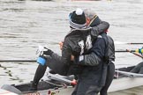 The Women's Boat Race season 2018 - fixture OUWBC vs. Molesey BC: Molesey cox Ella Taylor being carried to the boat by the MBC coach, much to the amusement of the crew.
River Thames between Putney Bridge and Mortlake,
London SW15,

United Kingdom,
on 04 March 2018 at 13:09, image #14
