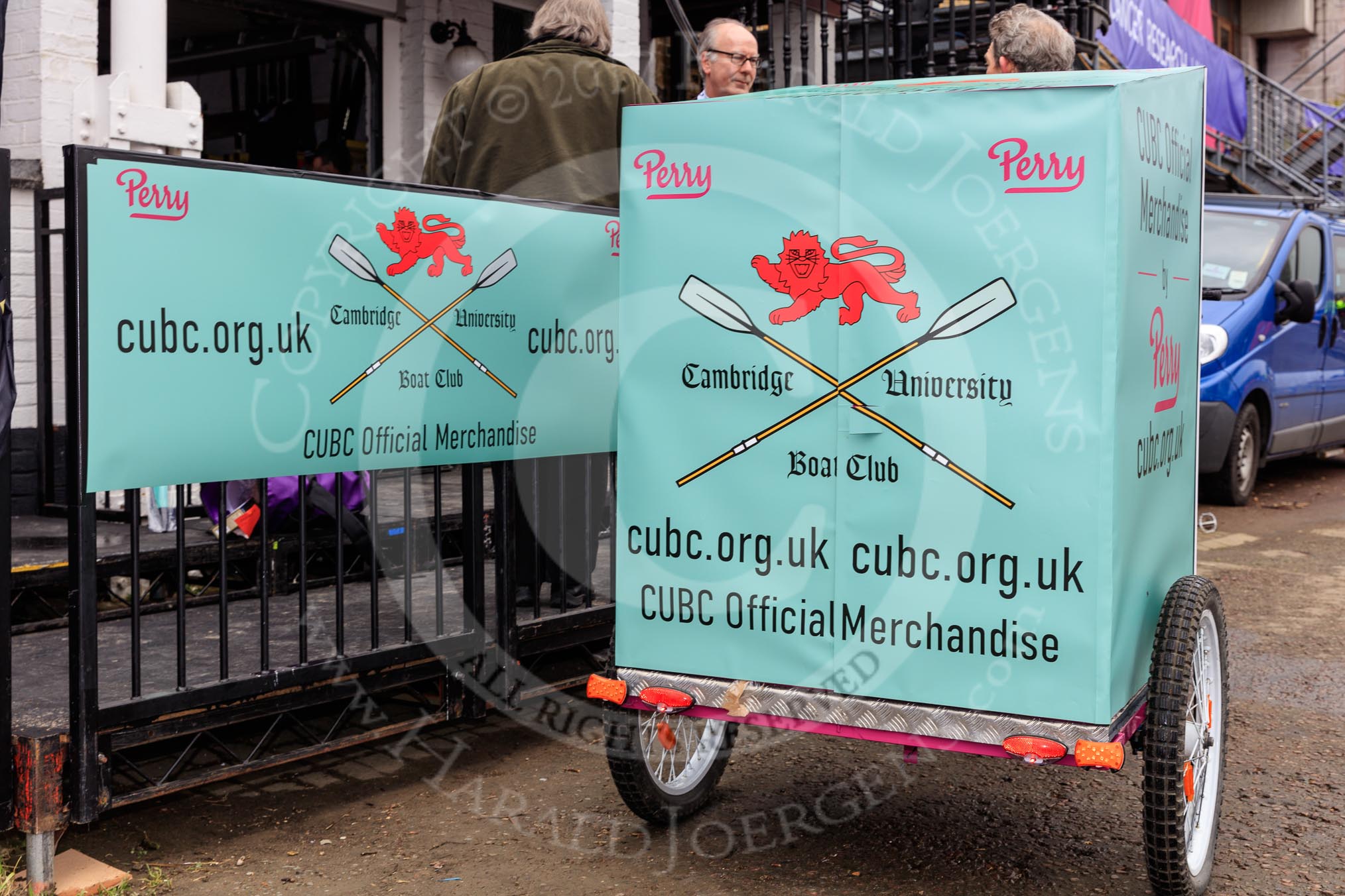 The Cancer Research UK Women's Boat Race 2018: CUBC with their "Official Merchandise" sales trailer.
River Thames between Putney Bridge and Mortlake,
London SW15,

United Kingdom,
on 24 March 2018 at 13:00, image #2