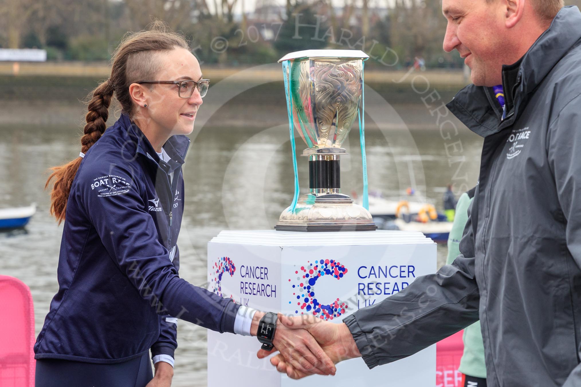 The Cancer Research UK Women's Boat Race 2018: OUWBC president Katherine Erickson shaking hands with race umpire Sir Matthew Pinsent after the toss, in front of the Women's Boat Race trophy.
River Thames between Putney Bridge and Mortlake,
London SW15,

United Kingdom,
on 24 March 2018 at 14:41, image #48