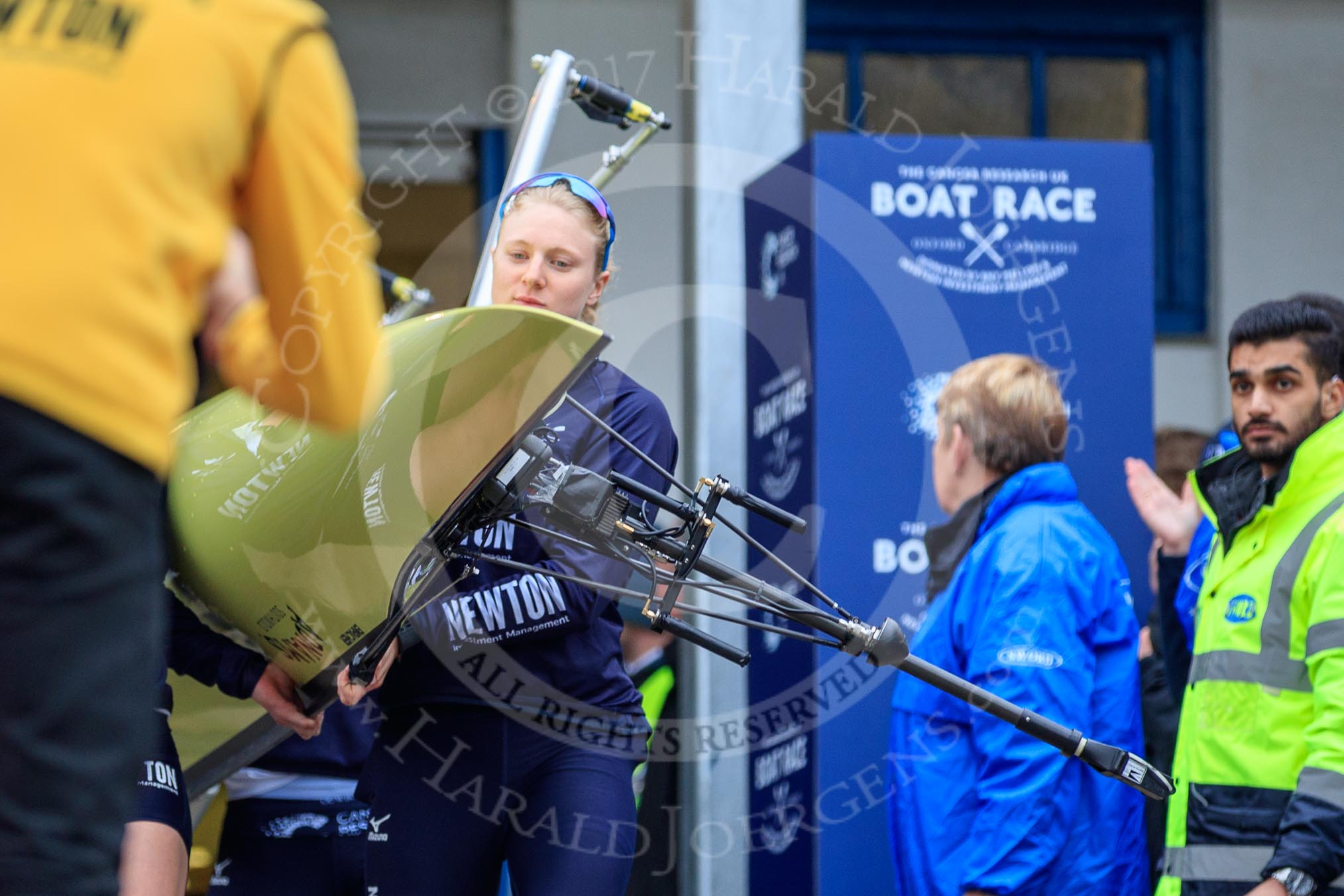 The Cancer Research UK Women's Boat Race 2018: THe Oxford boat, with the BBC camera assembly mounted on the rear, is carried out of the boathouse, In front stroke Beth Bridgman.
River Thames between Putney Bridge and Mortlake,
London SW15,

United Kingdom,
on 24 March 2018 at 15:42, image #88