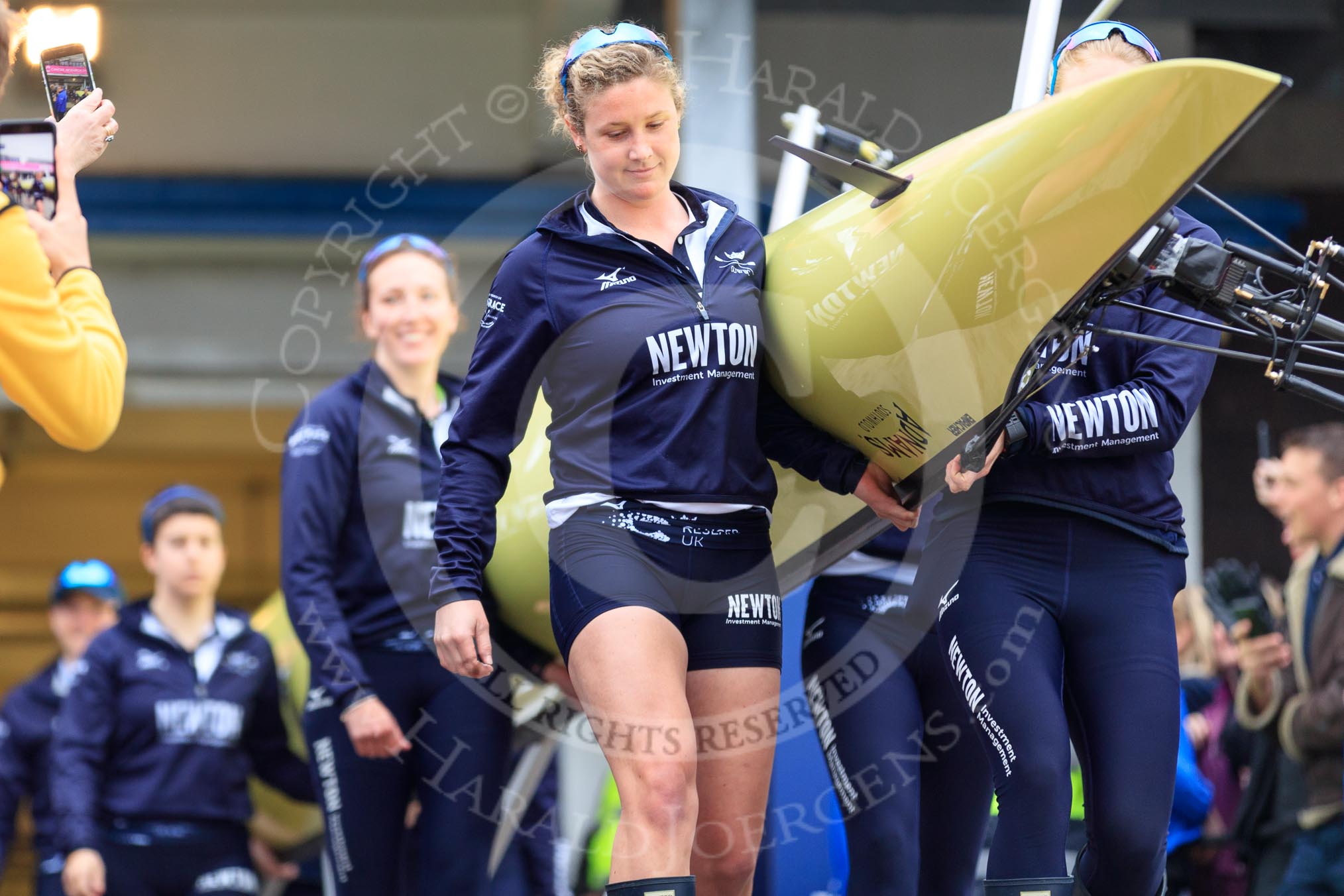 The Cancer Research UK Women's Boat Race 2018: THe Oxford boat  is carried out of the boathouse. In front 5 seat Morgan McGovern.
River Thames between Putney Bridge and Mortlake,
London SW15,

United Kingdom,
on 24 March 2018 at 15:42, image #91