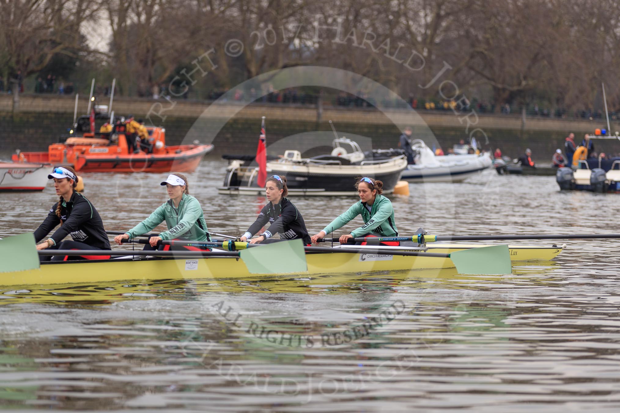 The Cancer Research UK Women's Boat Race 2018: The Cambridge Blue Boat leaving the boathouses area, here 4 seat Thea Zabell, 3 Kelsey Barolak, 2 Imogen Grant, and bow Tricia Smith.
River Thames between Putney Bridge and Mortlake,
London SW15,

United Kingdom,
on 24 March 2018 at 15:49, image #134