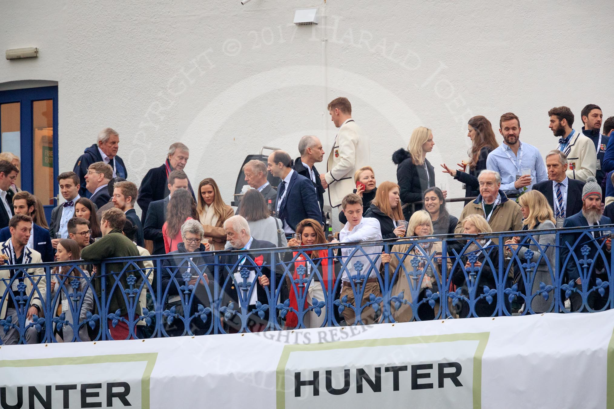 The Cancer Research UK Women's Boat Race 2018: The balconies of the many Putney Embankment boathouses are, as usual, crowded with spectators on race day.
River Thames between Putney Bridge and Mortlake,
London SW15,

United Kingdom,
on 24 March 2018 at 16:12, image #142