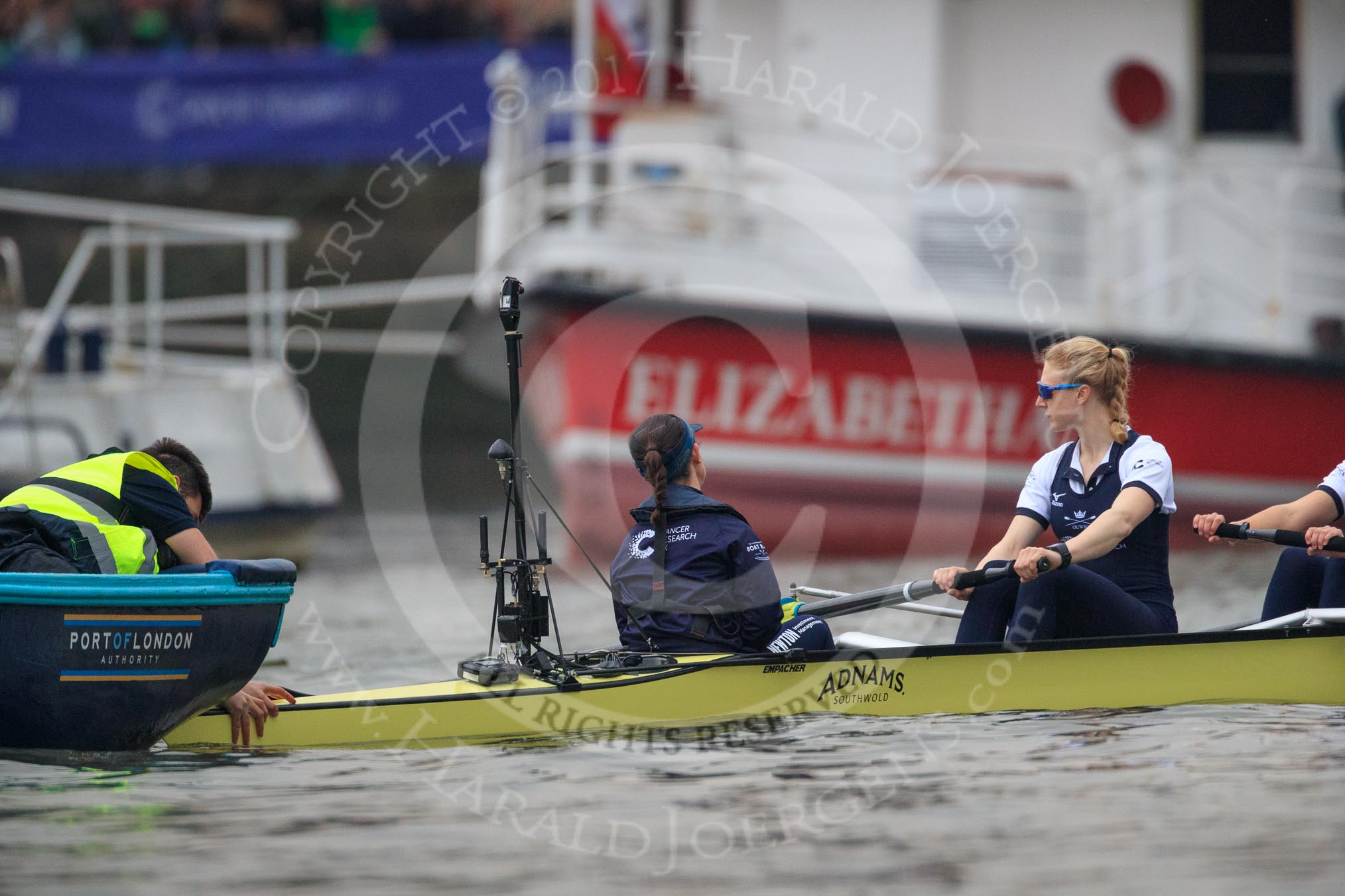 The Cancer Research UK Women's Boat Race 2018: The Oxford Blue Boat held in place at the stake boat, just before the start of the race: Cox Jessica Buck, stroke Beth Bridgman.
River Thames between Putney Bridge and Mortlake,
London SW15,

United Kingdom,
on 24 March 2018 at 16:28, image #160