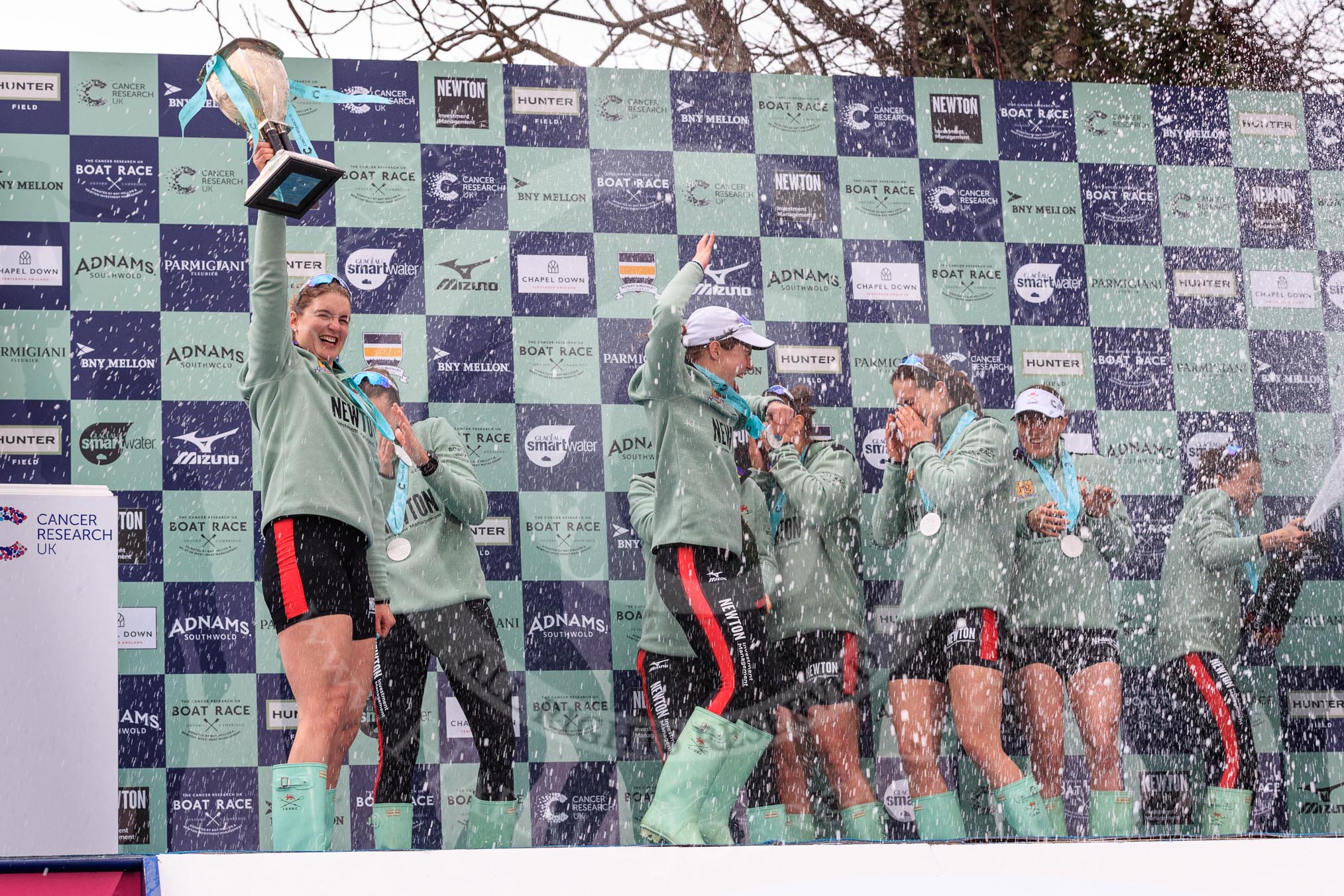 The Cancer Research UK Women's Boat Race 2018: The Cambridge women celebrating with their Boat Race medals, the Women's Boat Race trophy, and lots of Chapel Down Brut. With the trophy Myriam Goudet-Boukhatmi.
River Thames between Putney Bridge and Mortlake,
London SW15,

United Kingdom,
on 24 March 2018 at 17:09, image #283