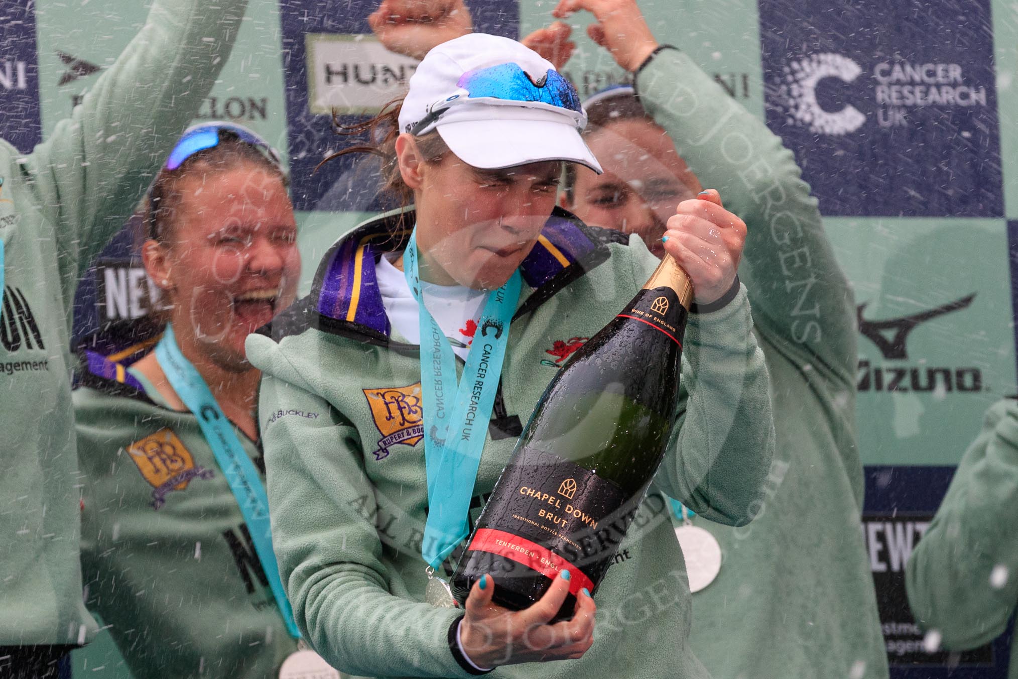 The Cancer Research UK Women's Boat Race 2018: Cambridge victory celebrations and lots of Chapel Down Brut sprayed all over the rowers, here Sophie Shapter, and behind her Paula Wesselmann and Myriam Goudet-Boukhatmi  (I guess).
River Thames between Putney Bridge and Mortlake,
London SW15,

United Kingdom,
on 24 March 2018 at 17:09, image #286