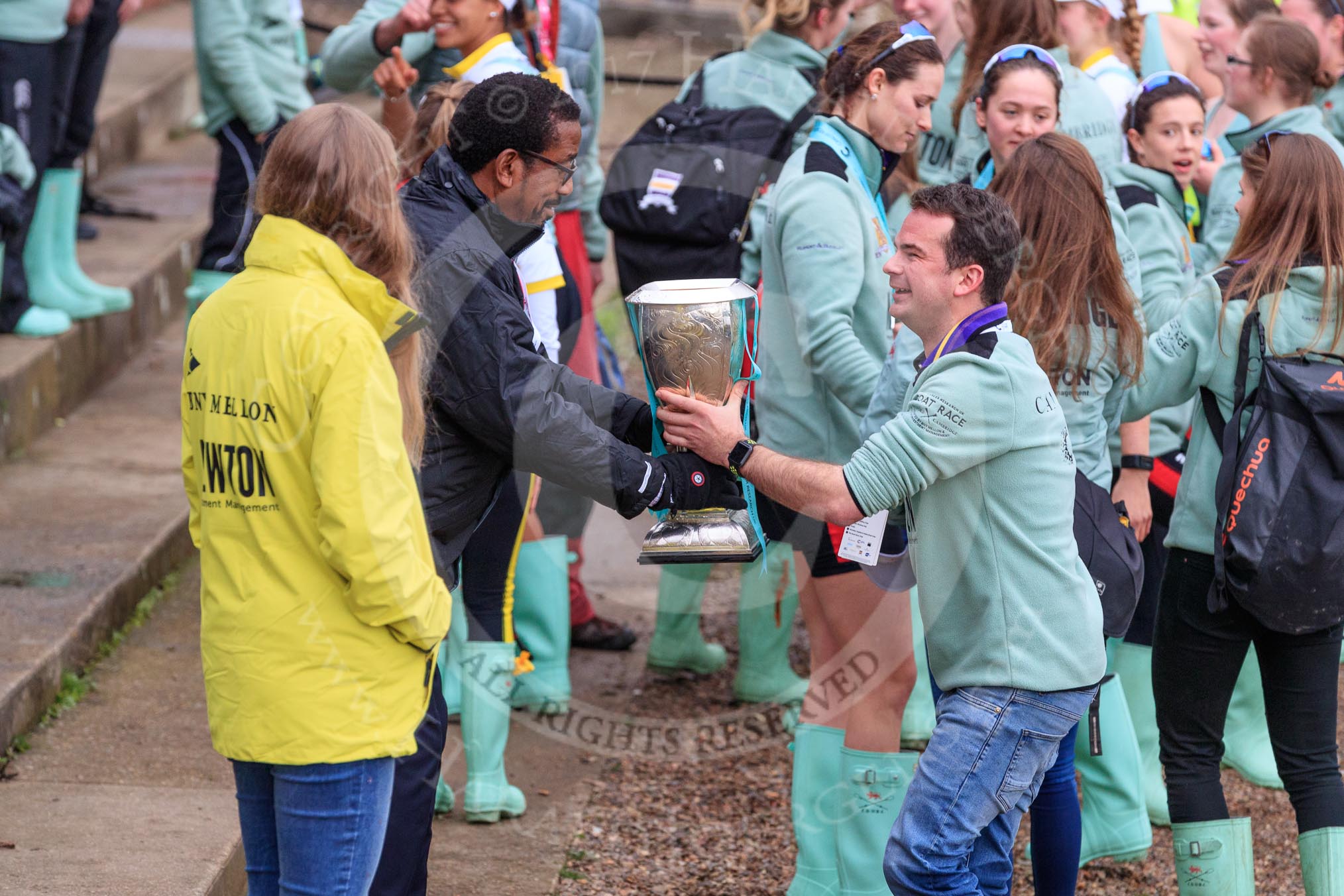 The Cancer Research UK Women's Boat Race 2018: The Women's Boat Race trophy is carried away, with CUWBC club coordinator James Lee volunteering to drink the remaining Chapel Down Brut from it.
River Thames between Putney Bridge and Mortlake,
London SW15,

United Kingdom,
on 24 March 2018 at 17:15, image #318