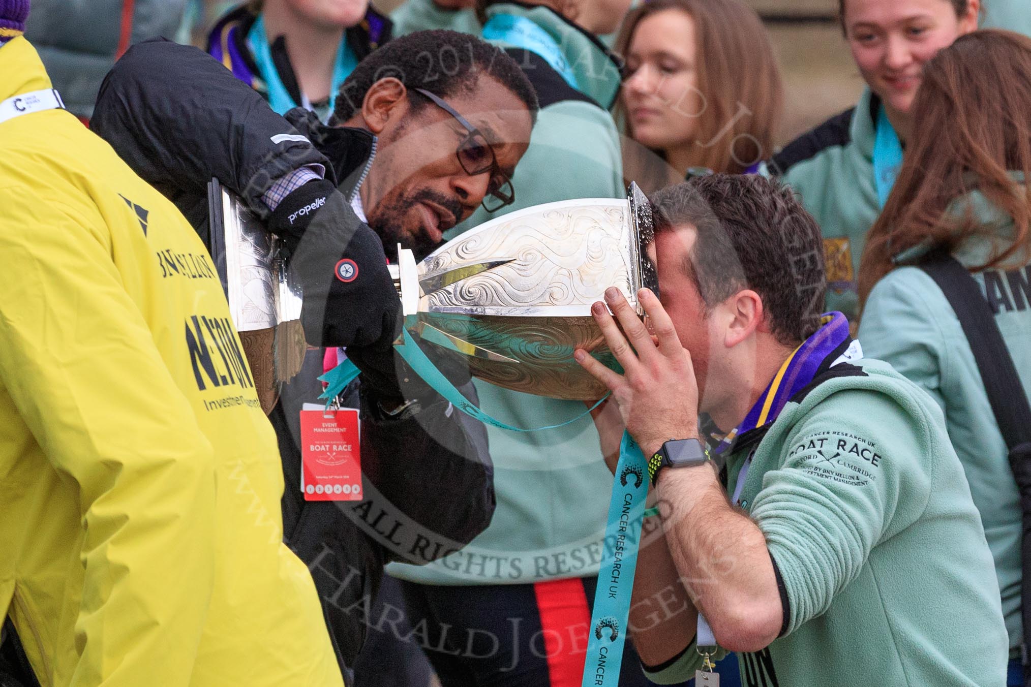 The Cancer Research UK Women's Boat Race 2018: The Women's Boat Race trophy is carried away, with CUWBC club coordinator James Lee volunteering to drink the remaining Chapel Down Brut from it.
River Thames between Putney Bridge and Mortlake,
London SW15,

United Kingdom,
on 24 March 2018 at 17:15, image #319