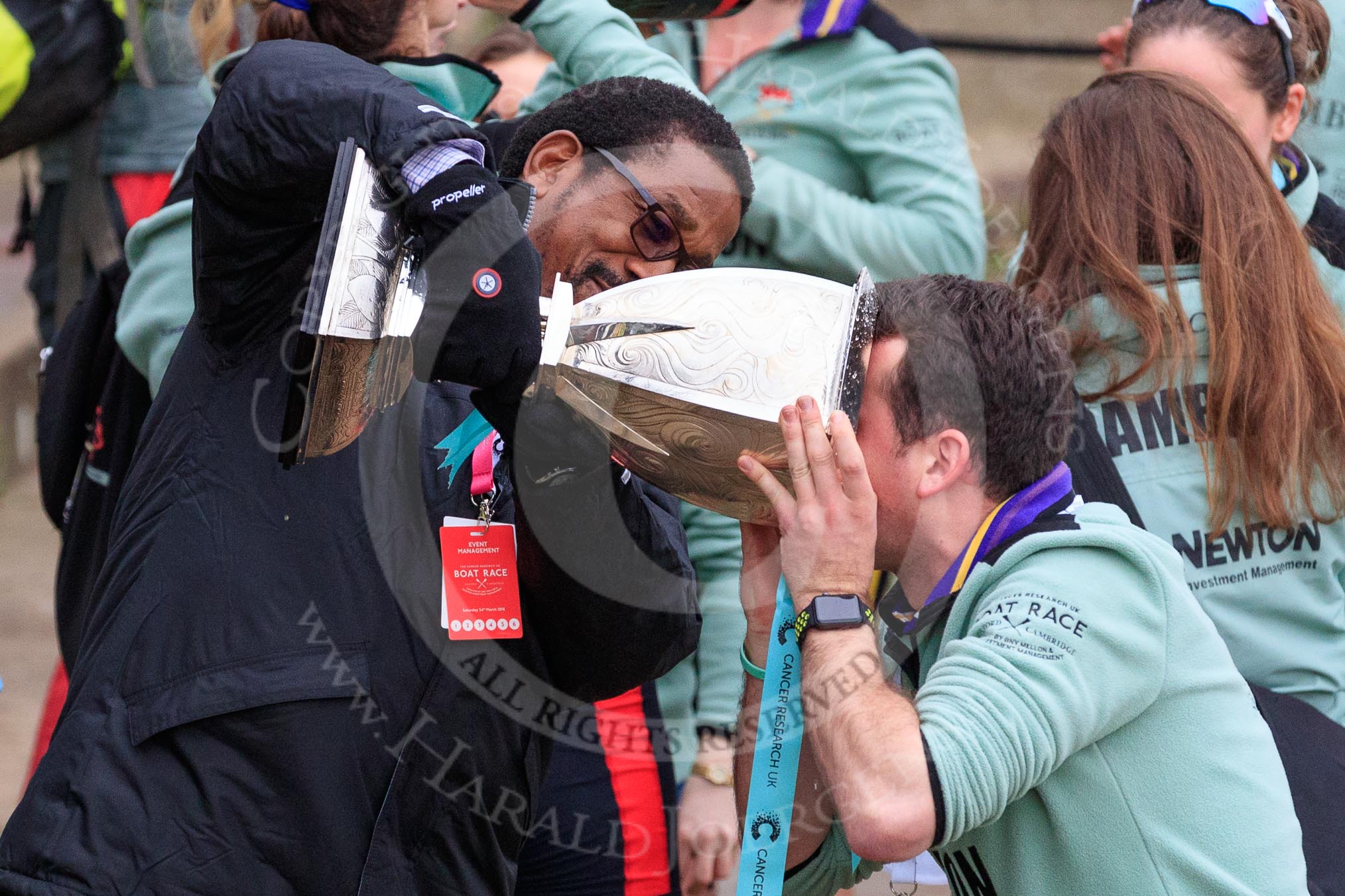 The Cancer Research UK Women's Boat Race 2018: The Women's Boat Race trophy is carried away, with CUWBC club coordinator James Lee volunteering to drink the remaining Chapel Down Brut from it.
River Thames between Putney Bridge and Mortlake,
London SW15,

United Kingdom,
on 24 March 2018 at 17:15, image #320