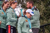 The Cancer Research UK Women's Boat Race 2018: Thea Zabell, Alice White, and Sophie Shapter leaving the podium, all still wet after spraying lots of Castle Down Brut. On the right, with the Boat Race trophy, Vambridge Head coach Rob Baker.
River Thames between Putney Bridge and Mortlake,
London SW15,

United Kingdom,
on 24 March 2018 at 17:10, image #304