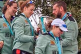 The Cancer Research UK Women's Boat Race 2018: Thea Zabell, Alice White, and Sophie Shapter leaving the podium, all still wet after spraying lots of Castle Down Brut. On the right, with the Boat Race trophy, Vambridge Head coach Rob Baker.
River Thames between Putney Bridge and Mortlake,
London SW15,

United Kingdom,
on 24 March 2018 at 17:10, image #303