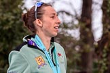 The Cancer Research UK Women's Boat Race 2018: Cambridge stroke Olivia Coffey  leaving the podium, still wet from the champagne that had been sprayed.
River Thames between Putney Bridge and Mortlake,
London SW15,

United Kingdom,
on 24 March 2018 at 17:10, image #306