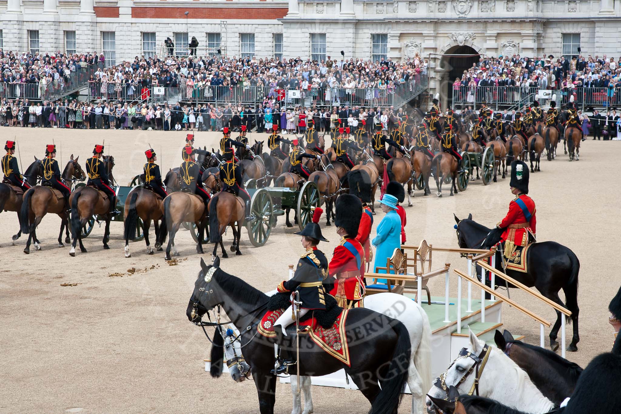 Trooping the Colour 2009: The King's Troop Royal Horse Artillery riding past Her Majesty. Next to the aluting base are the Royal Colonels - in front, HRH Princess Anne, the Princess Royal, next to her HRH Prince Edward, The Duke of Kent, amd on the other side of the dais HRH Prince Charles, The Prince of Wales..
Horse Guards Parade, Westminster,
London SW1,

United Kingdom,
on 13 June 2009 at 11:58, image #240