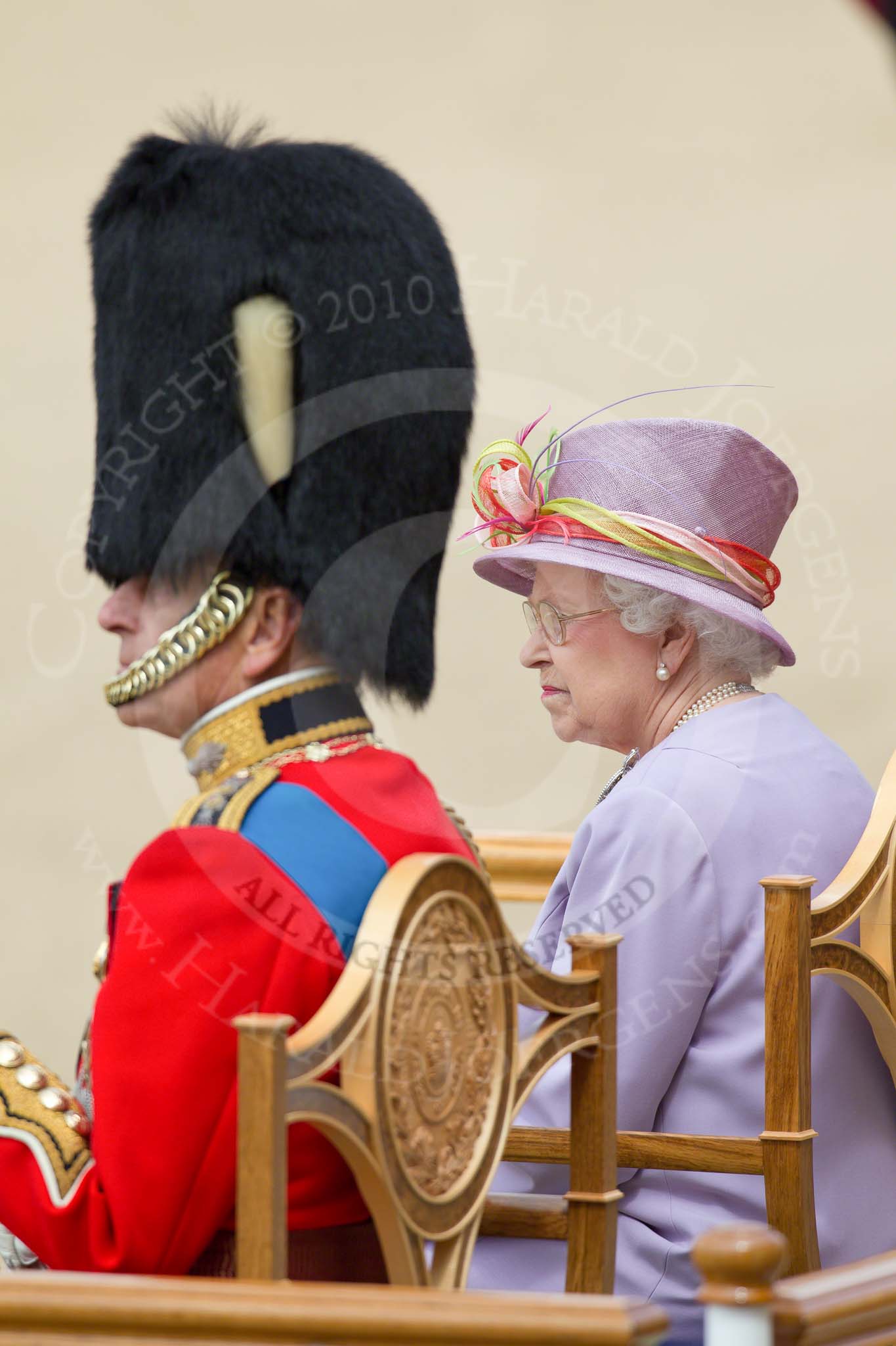 Trooping the Colour 2010: Her Majesty the Queen, Elizabeth II, and The Prince Philip. Duke of Edinburgh, during the &quot;Massed Bands Troop&quot;, sitting in their chairs on the saluting dais..
Horse Guards Parade, Westminster,
London SW1,
Greater London,
United Kingdom,
on 12 June 2010 at 11:26, image #131