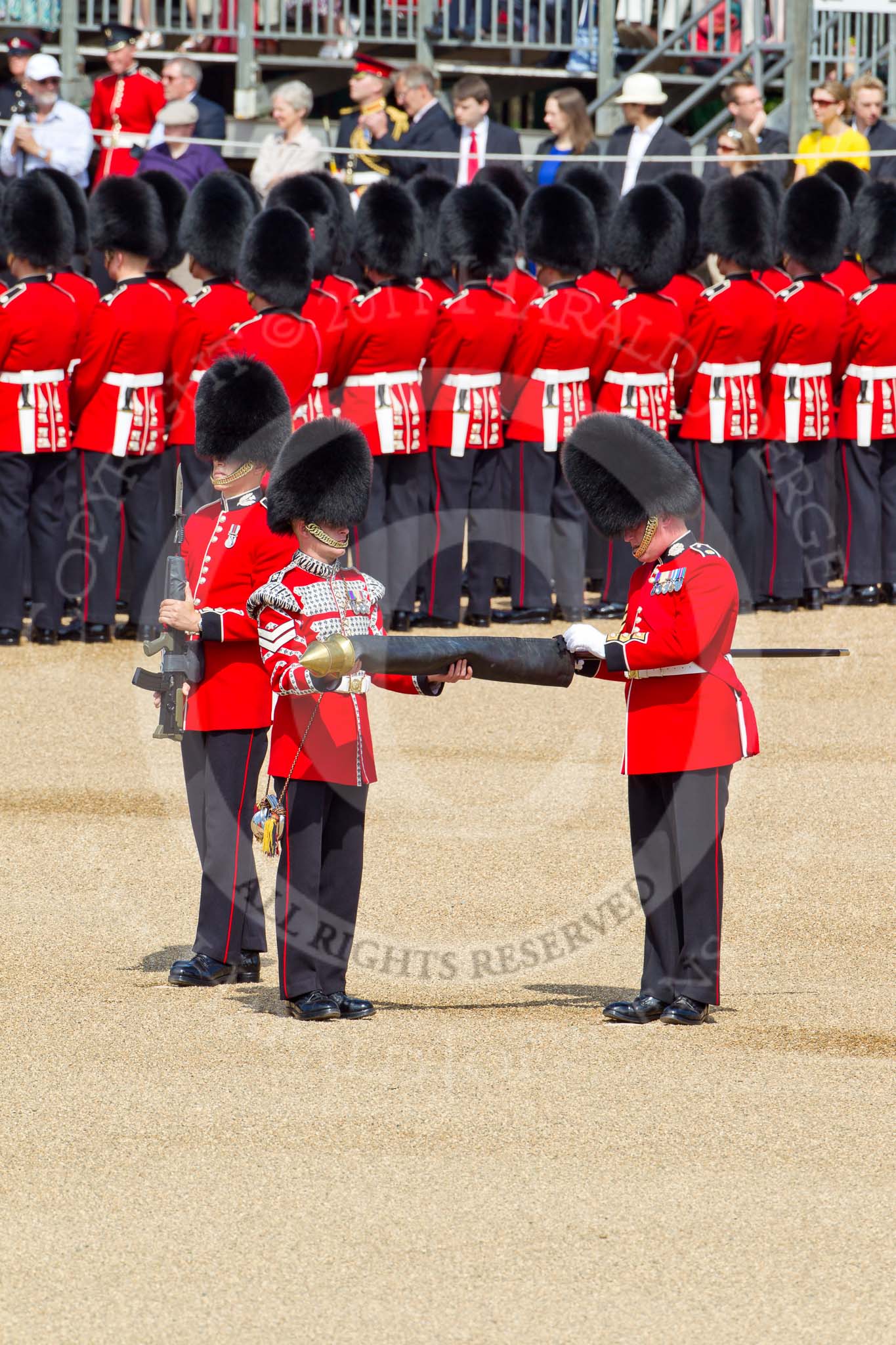 The Colonel's Review 2011: Uncasing the Colour. Colour Sergeant Chris Millin is opening the Colour Case, assisted by the Duty Drummer. Behind the drummer, presenting arms, one of the two sentries..
Horse Guards Parade, Westminster,
London SW1,

United Kingdom,
on 04 June 2011 at 10:33, image #43