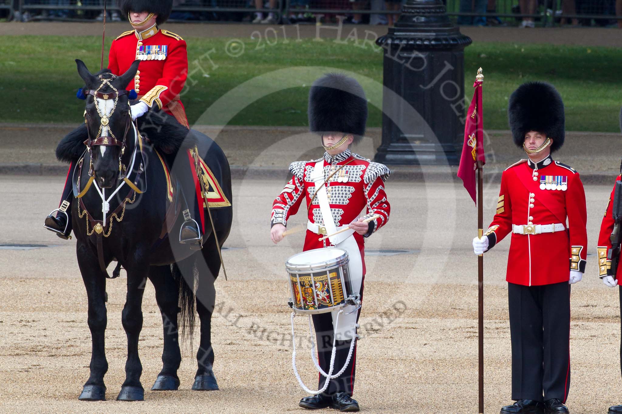 The Colonel's Review 2011: From left to right: Major B P N Ramsay, Welsh Guards, The Major of the Parade, then the 'Lone Drummer', Lance Corporal Gordon Prescott, Scots Guards, and the 'Keeper of the Ground' of No. 1 Guard, 1st Battalion Scots Guards..
Horse Guards Parade, Westminster,
London SW1,

United Kingdom,
on 04 June 2011 at 11:14, image #118